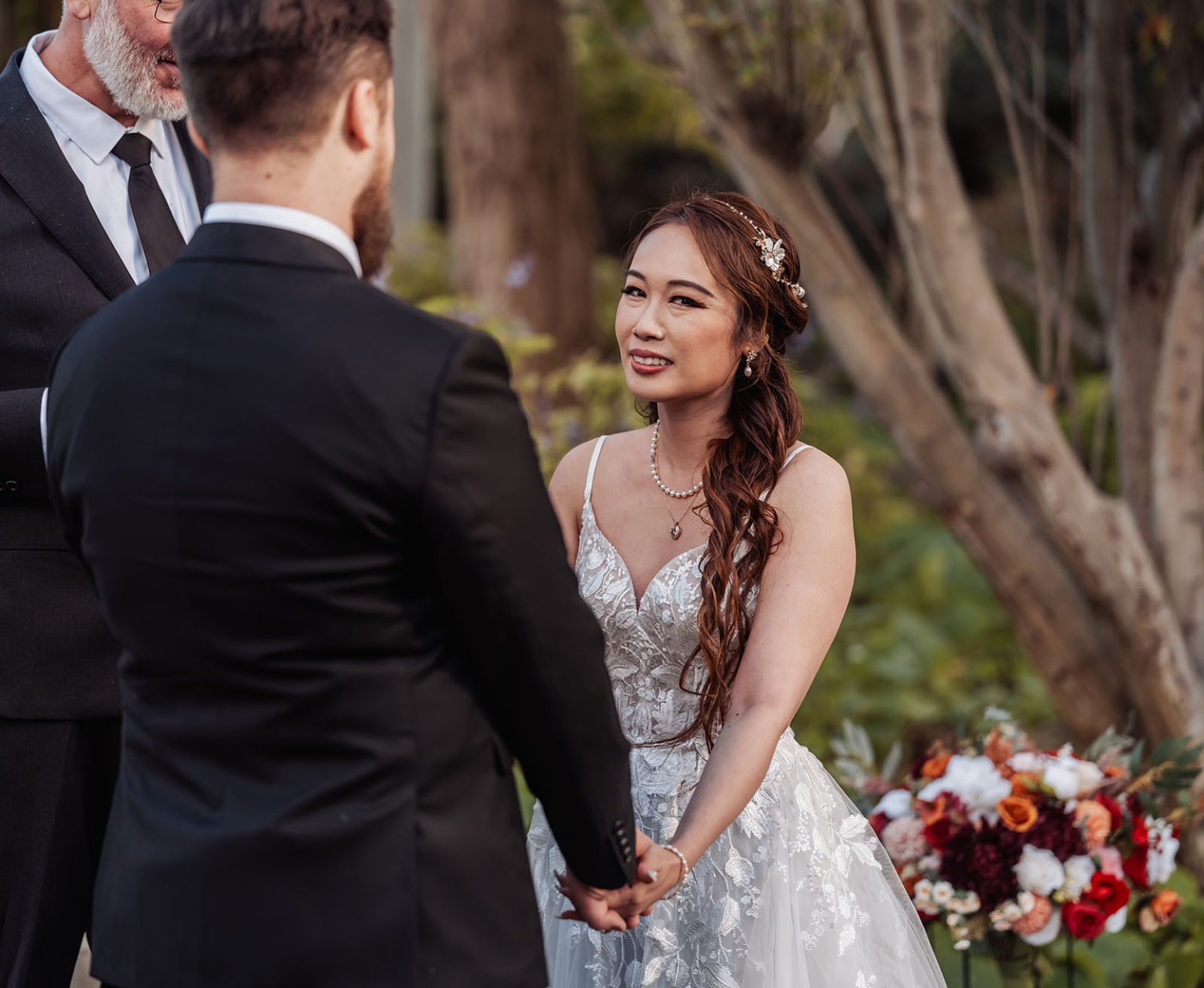 wedding at al-ru farm – teresa & thomas 19 Outdoor wedding ceremony with bride and groom holding hands in a romantic garden.