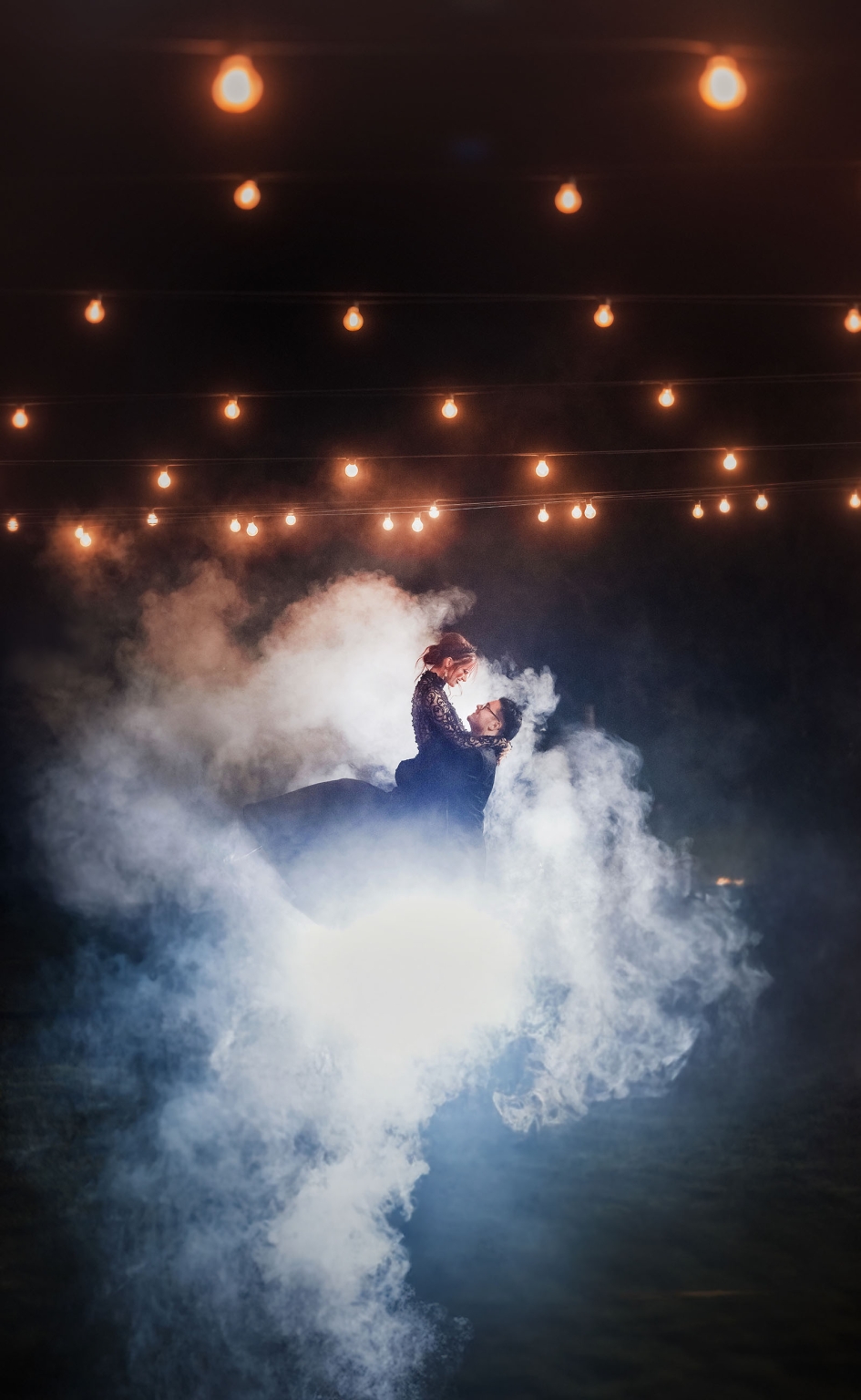 kuitpo hall wedding - courtney & jarrod 268 Romantic couple dancing in fog under warm string lights.
