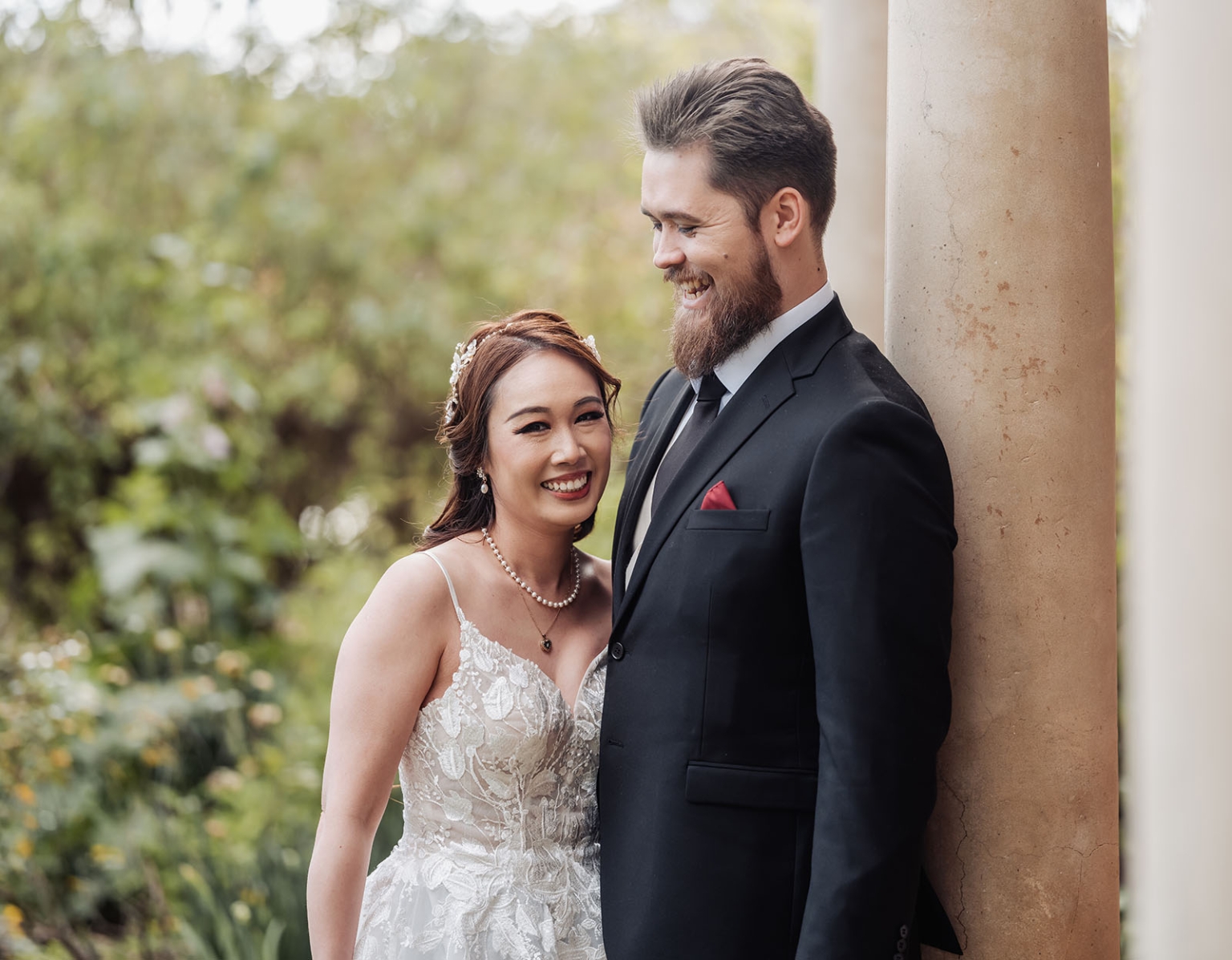 the night before the wedding: how brides can wake up with camera-ready hair 107 Bride and groom smiling in romantic outdoor garden wedding portrait.