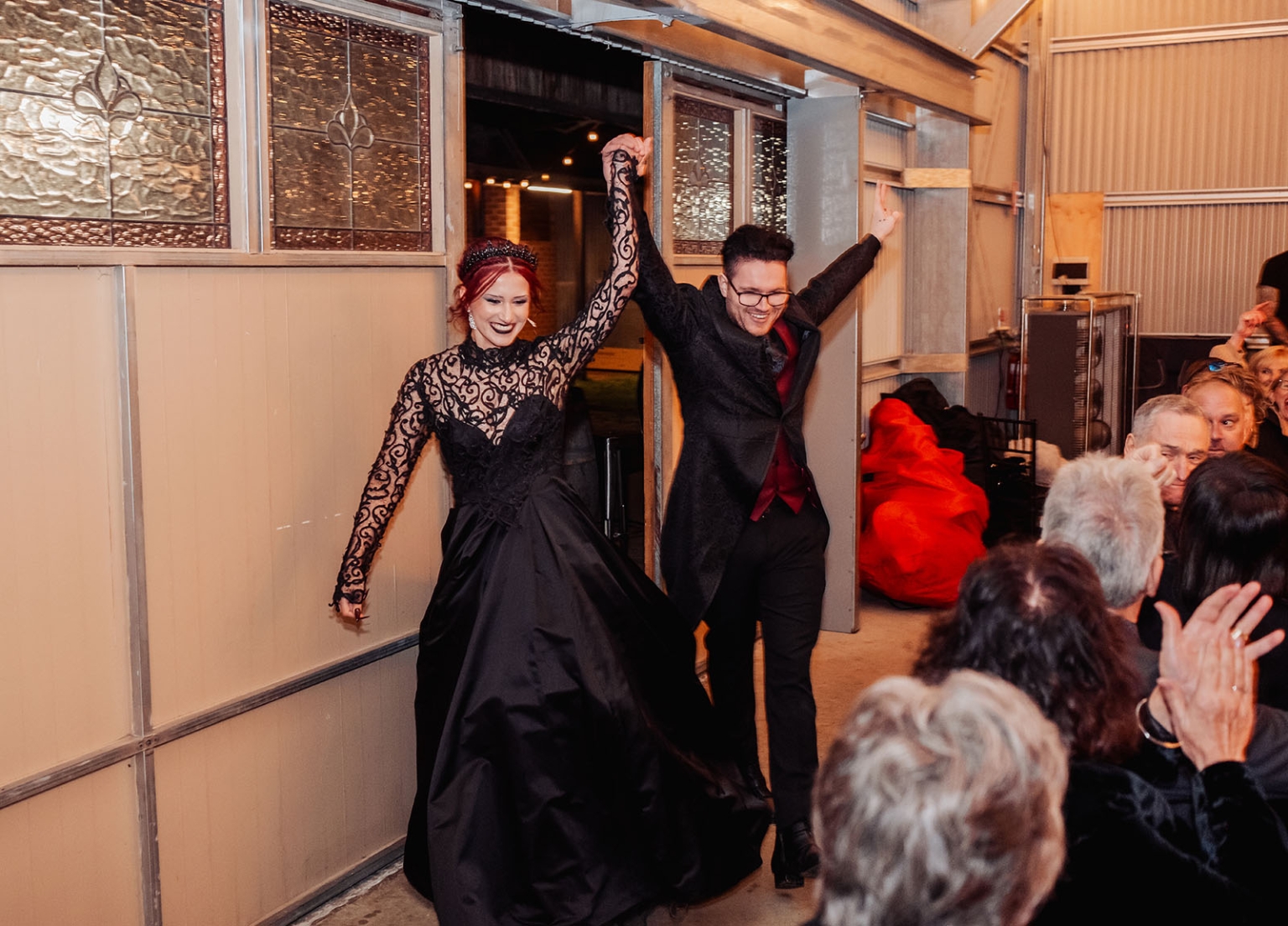 kuitpo hall wedding - courtney & jarrod 257 Gothic wedding couple makes a joyful grand entrance as guests applaud.