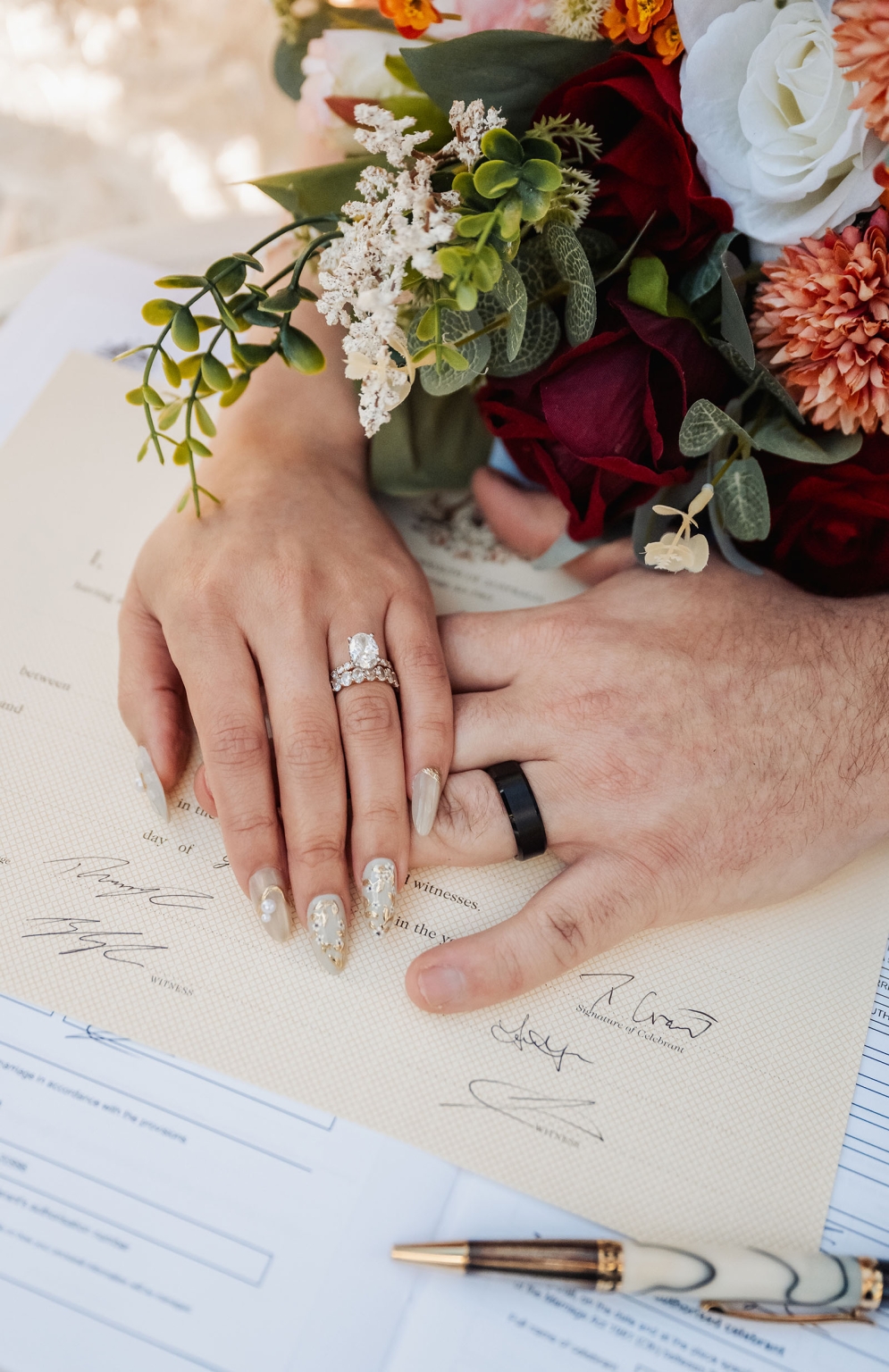 wedding at al-ru farm – teresa & thomas 26 Wedding rings on signed marriage certificate with bridal bouquet.
