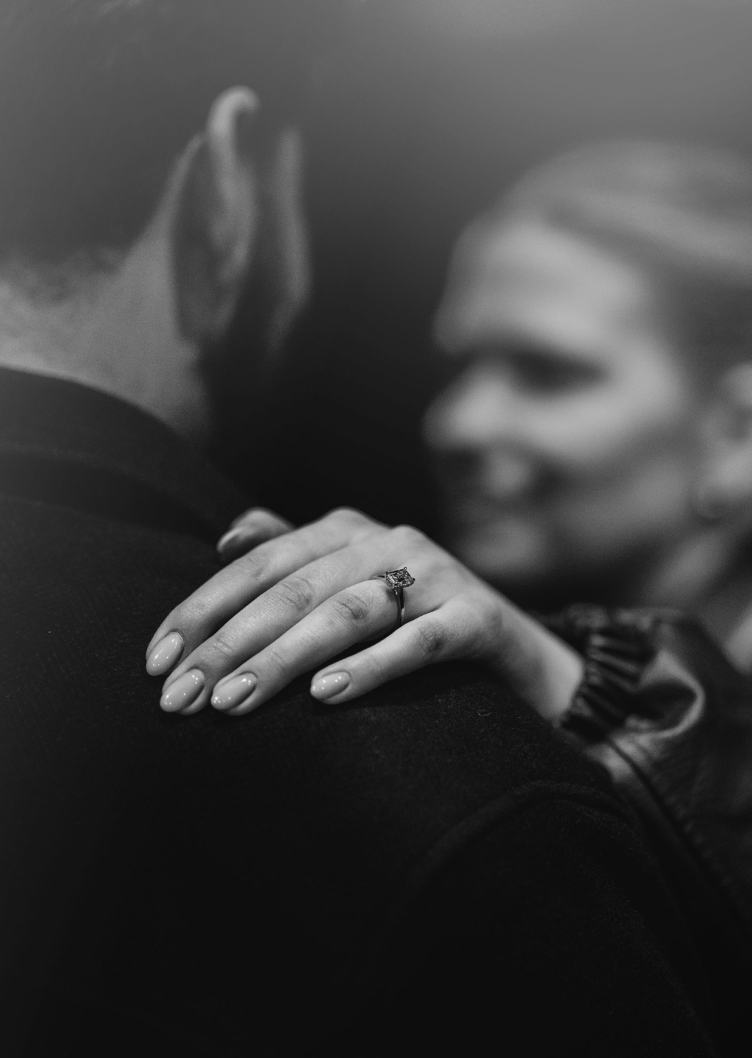 elder park rotunda proposal - lauren & enrique 8 Woman's hand wearing an engagement ring resting on her partner's shoulder