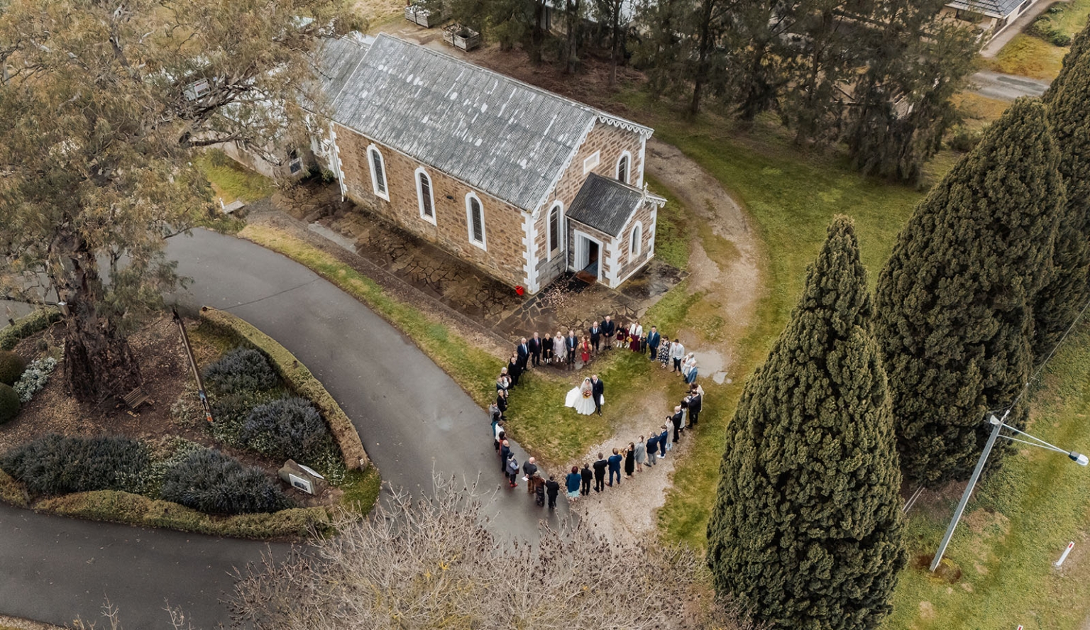 keyneton soldier's memorial hall wedding - lara & simon 17 Aerial view of wedding guests forming a heart around the newlyweds outside Keyneton Church