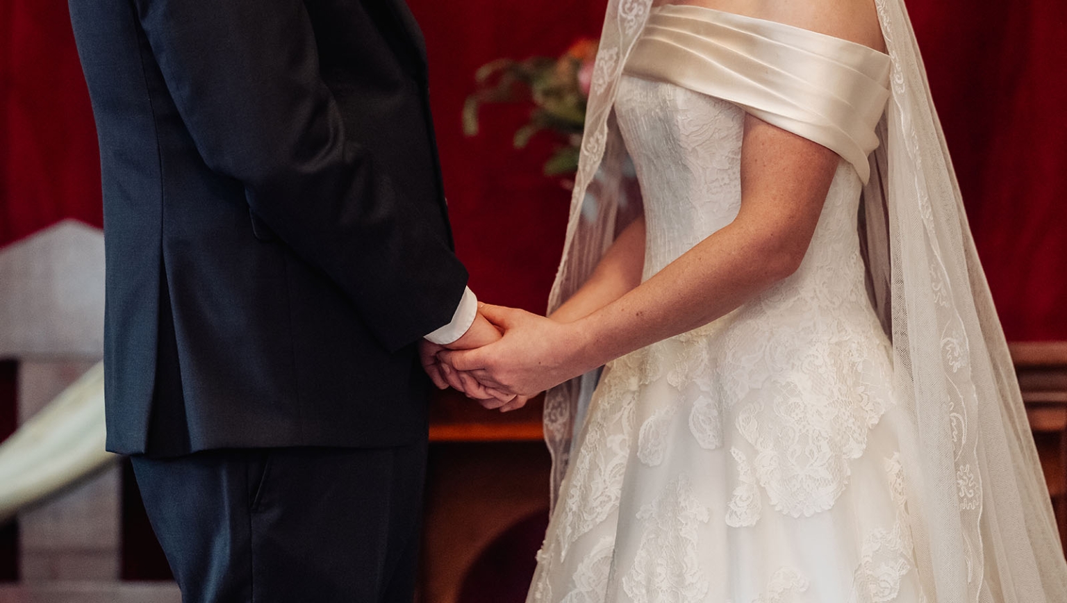 keyneton soldier's memorial hall wedding - lara & simon 8 Lara and Simon holding hands during their wedding ceremony, with Lara wearing a lace wedding dress and veil.