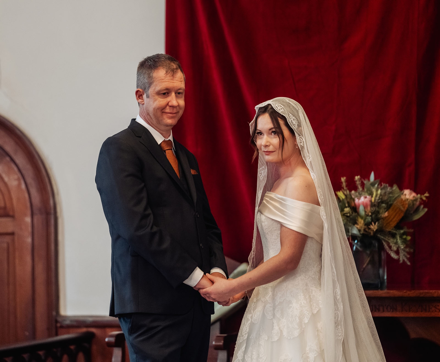 keyneton soldier's memorial hall wedding - lara & simon 7 Lara and Simon holding hands during their wedding ceremony in the Keyneton church