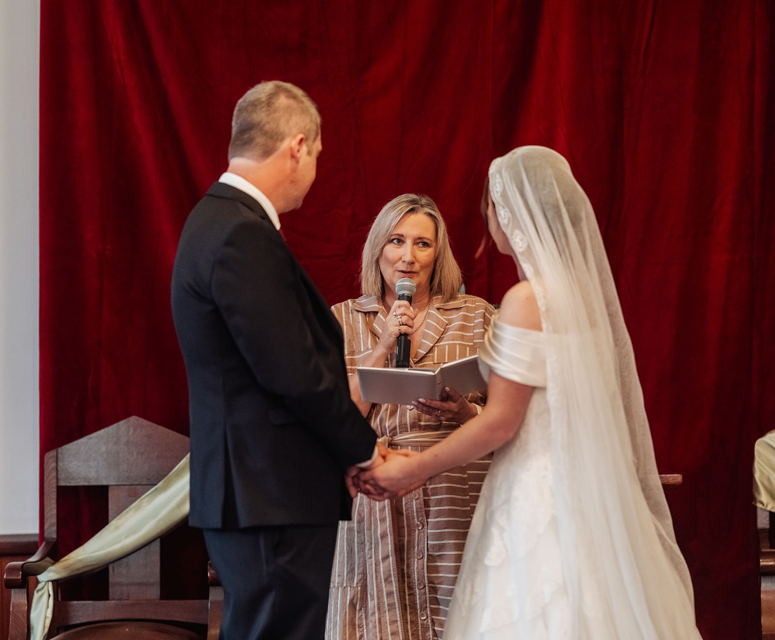 keyneton soldier's memorial hall wedding - lara & simon 13 Lara and Simon holding hands as their celebrant speaks during their Keyneton church wedding ceremony