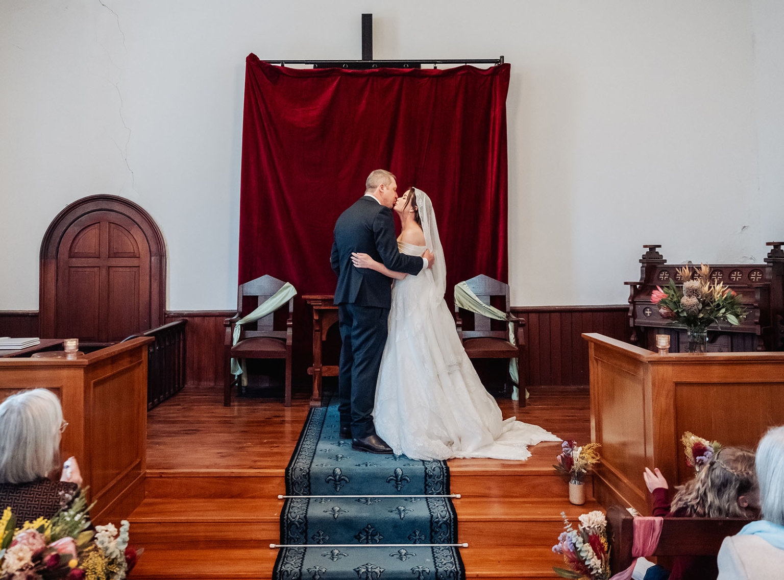 keyneton soldier's memorial hall wedding - lara & simon 14 Lara and Simon kissing at the altar during their wedding ceremony in Keyneton church