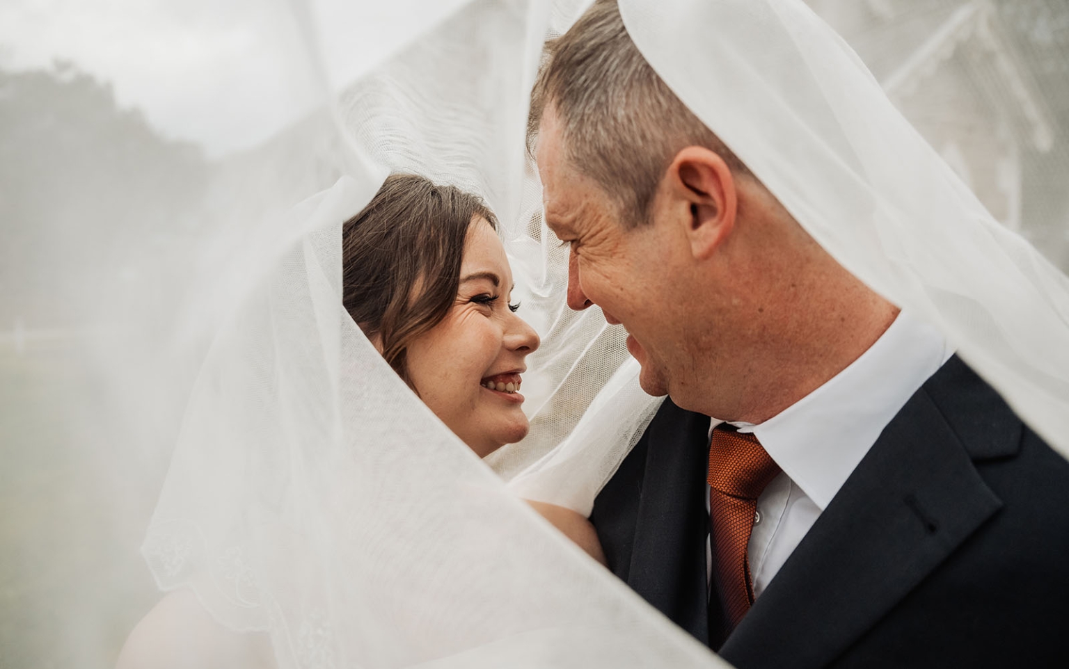keyneton soldier's memorial hall wedding - lara & simon 18 Lara and Simon smiling closely beneath Lara’s wedding veil