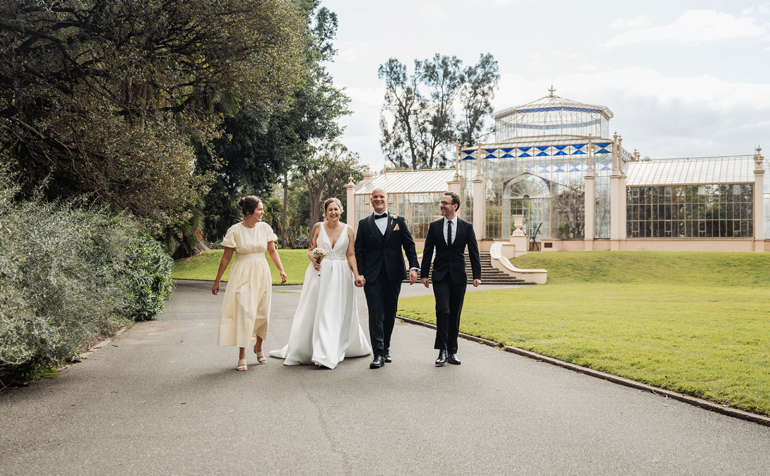 marriage registration office wedding - mia & roberto 73 Mia and Roberto walking with two guests along a garden path in front of a glasshouse at Adelaide Botanic Garden