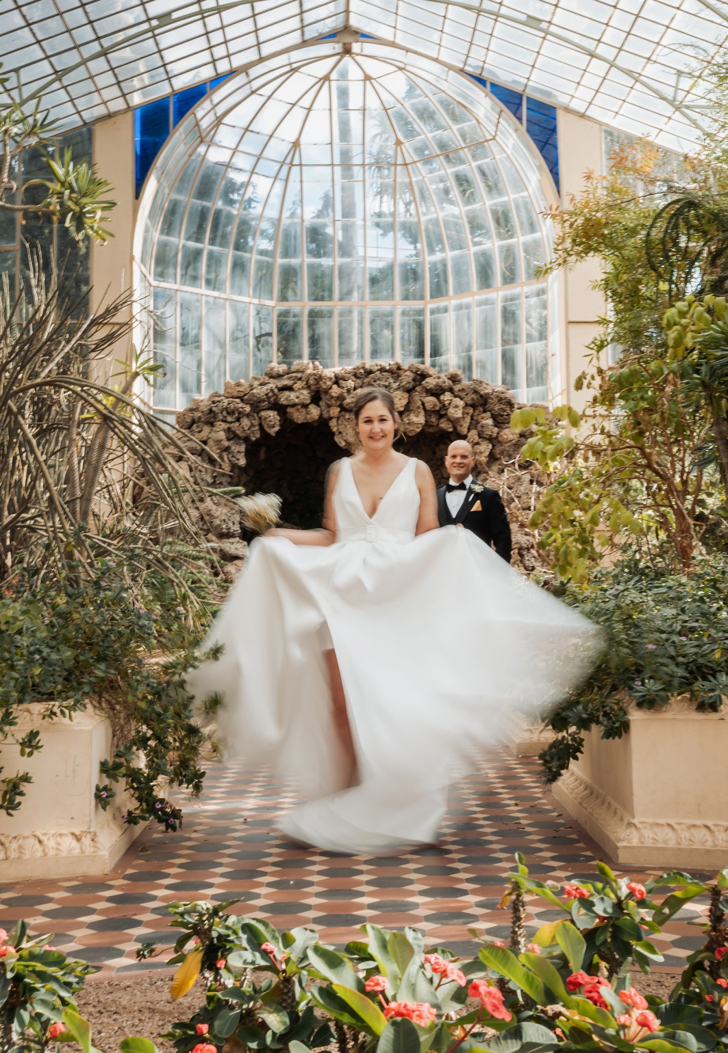 marriage registration office wedding - mia & roberto 70 Bride twirling her white wedding dress beside the groom inside a lush glasshouse with a tiled floor