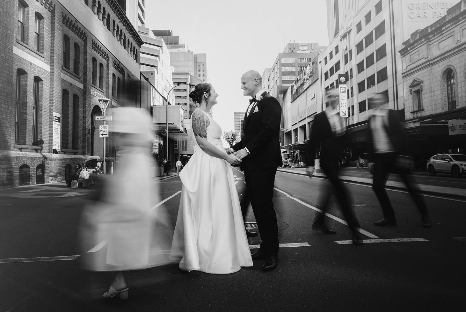 marriage registration office wedding - mia & roberto 98 Mia and Roberto holding hands on Grenfell Street in Adelaide as pedestrians blur past