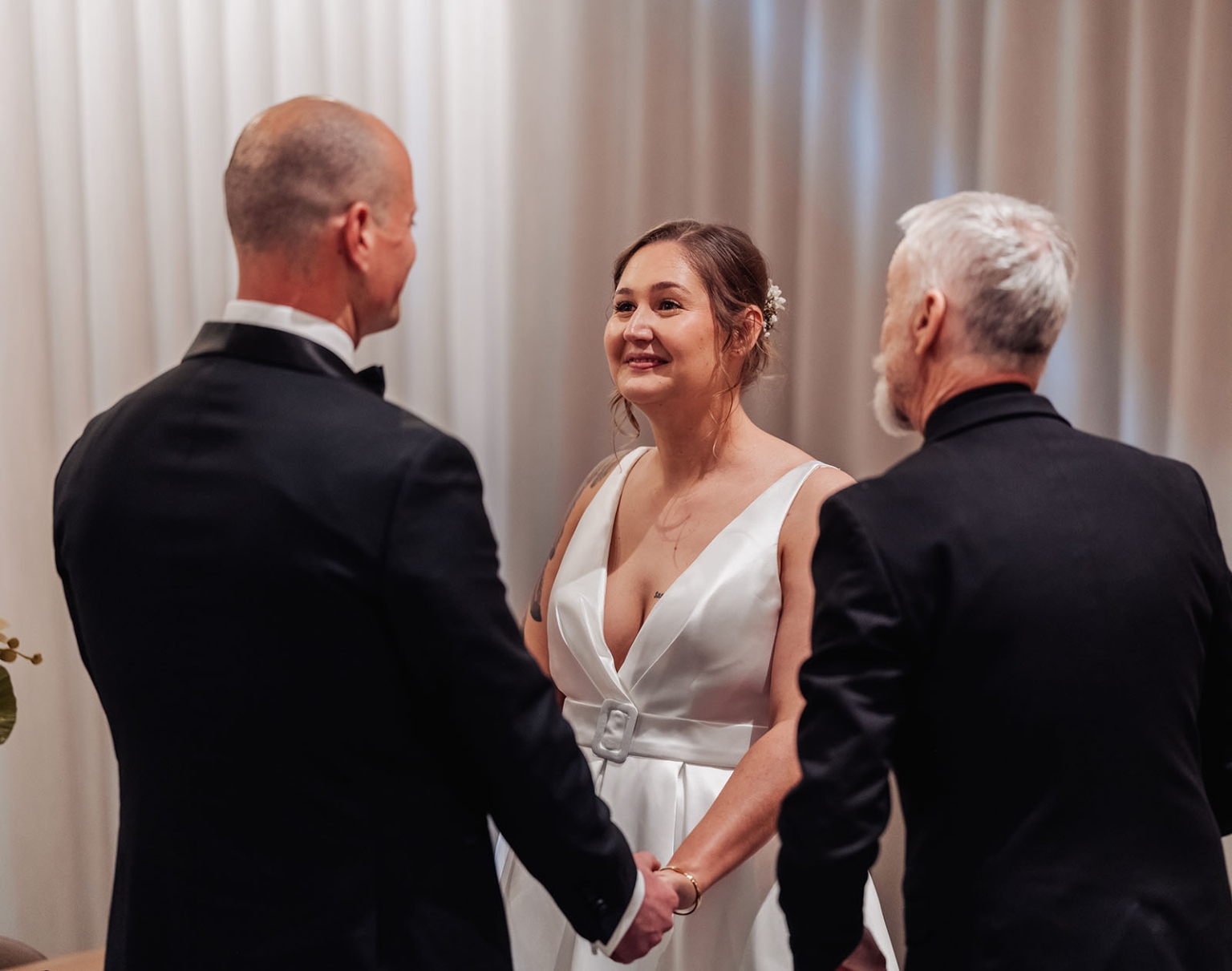 marriage registration office wedding - mia & roberto 87 Mia smiles at Roberto as they hold hands during their marriage ceremony with an officiant.