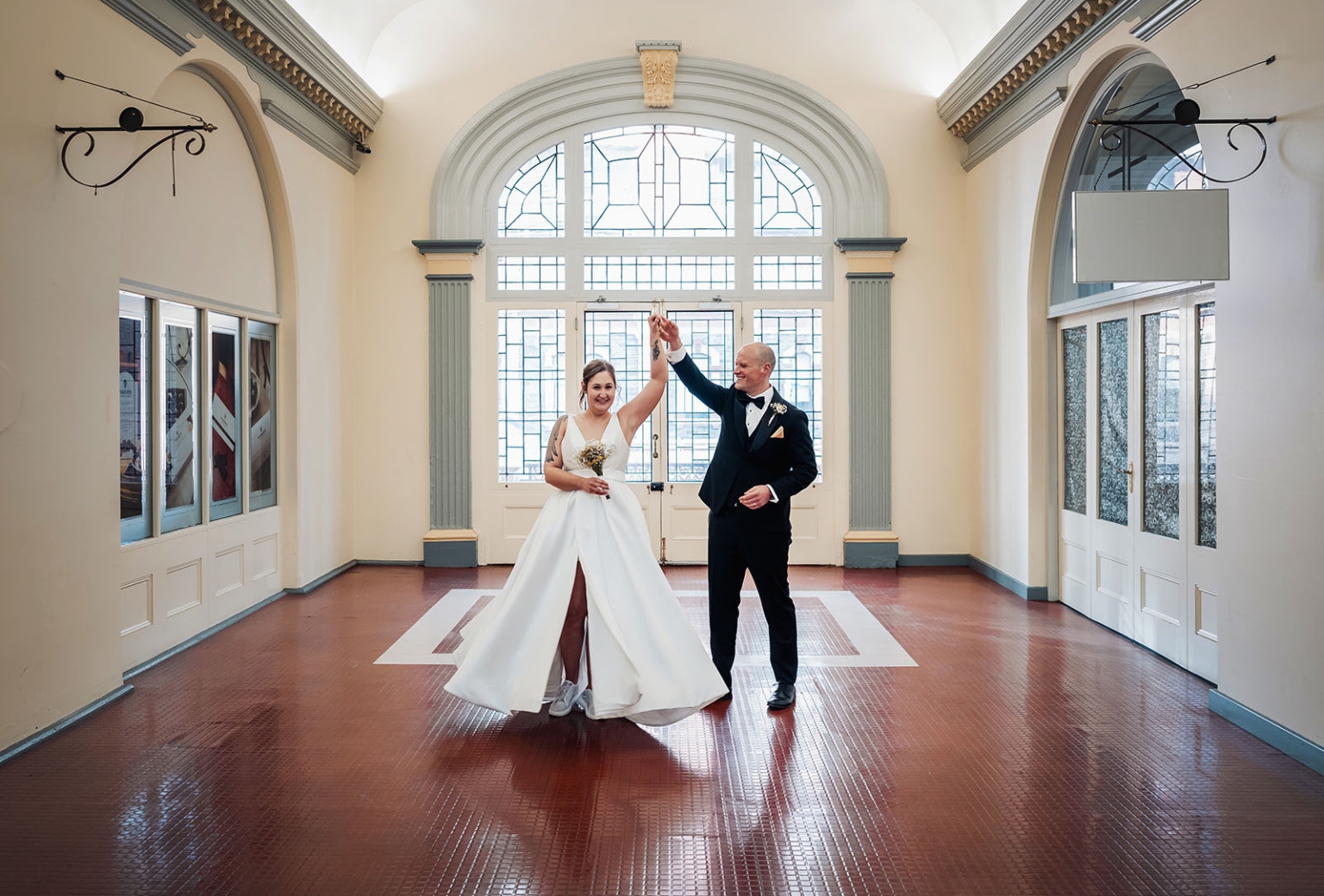 marriage registration office wedding - mia & roberto 99 Bride and groom dancing beneath an arched stained-glass window at the Adelaide Marriage and Registration Office