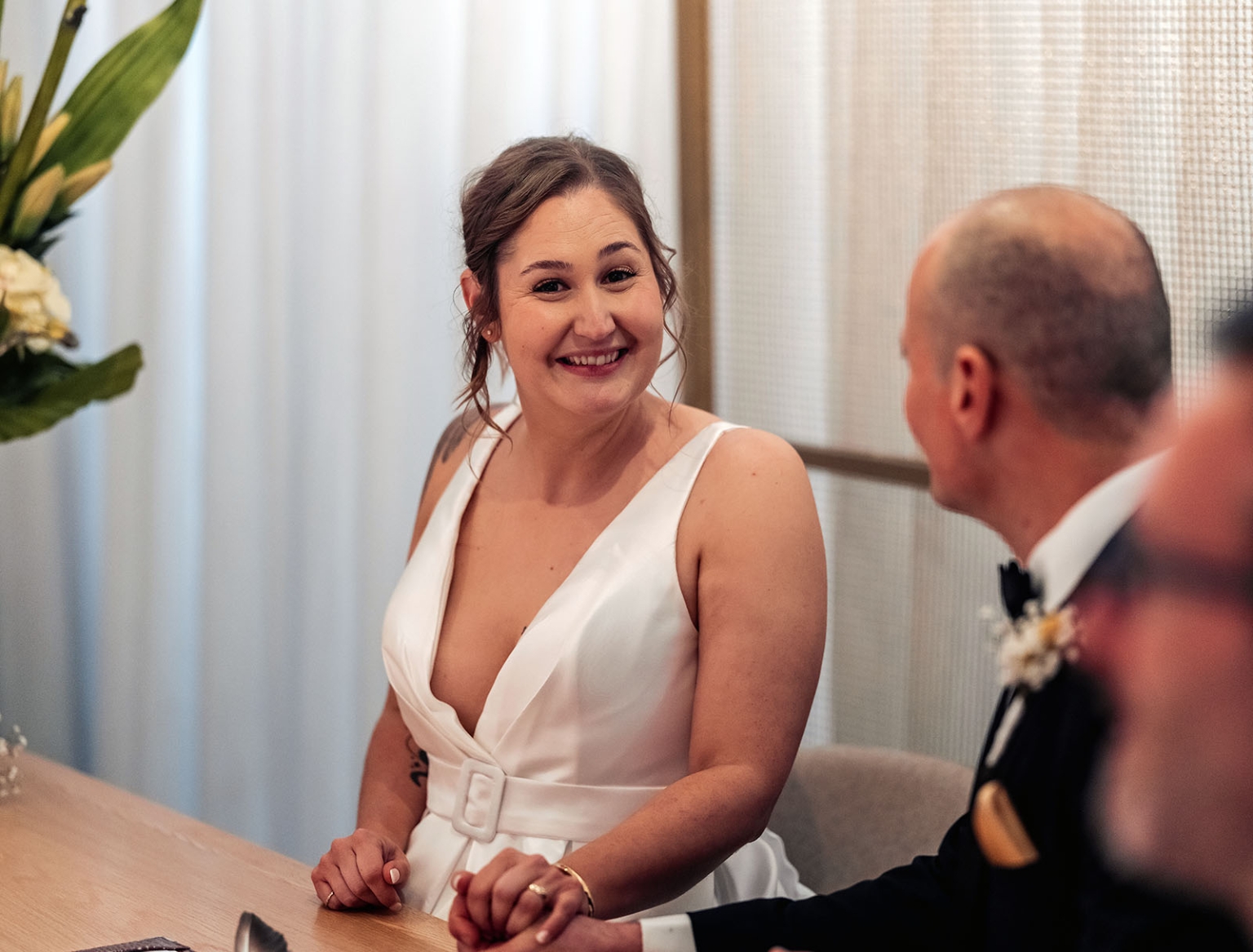 marriage registration office wedding - mia & roberto 90 Mia smiling at Roberto while seated at a table during their marriage registration ceremony