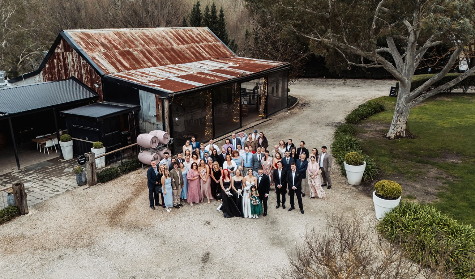 Wedding guests gathered outside the rustic Barristers Block building, viewed from above