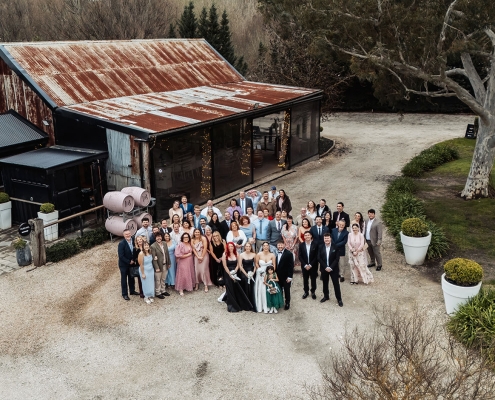 Wedding guests gathered outside the rustic Barristers Block building, viewed from above