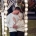 Kyle and Bianca embracing beneath strings of fairy lights, with Bianca’s engagement ring visible.