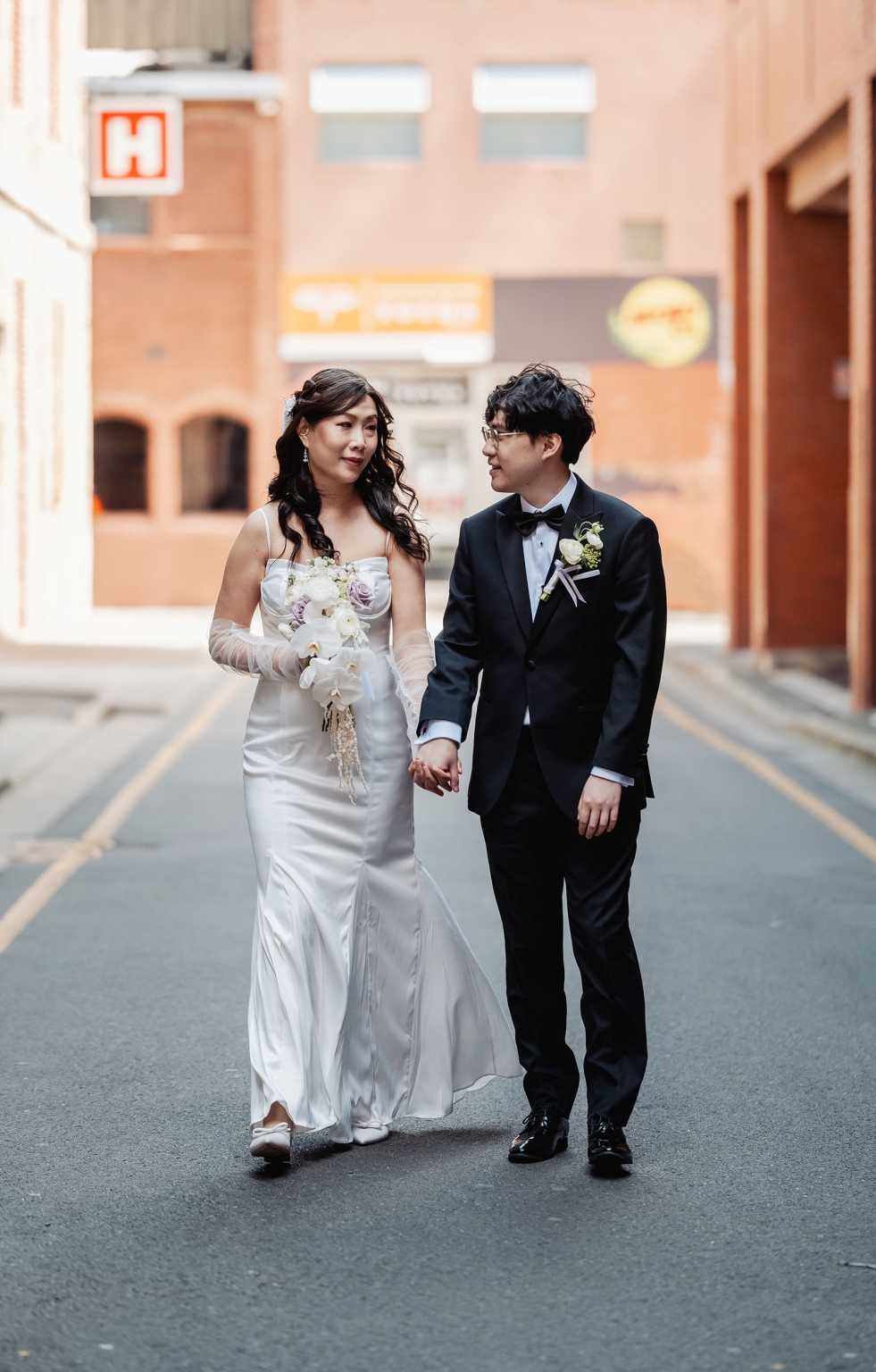 marriage rego office wedding – teri & thomas 17 Teri and Thomas walking hand in hand in an Adelaide laneway after their wedding ceremony