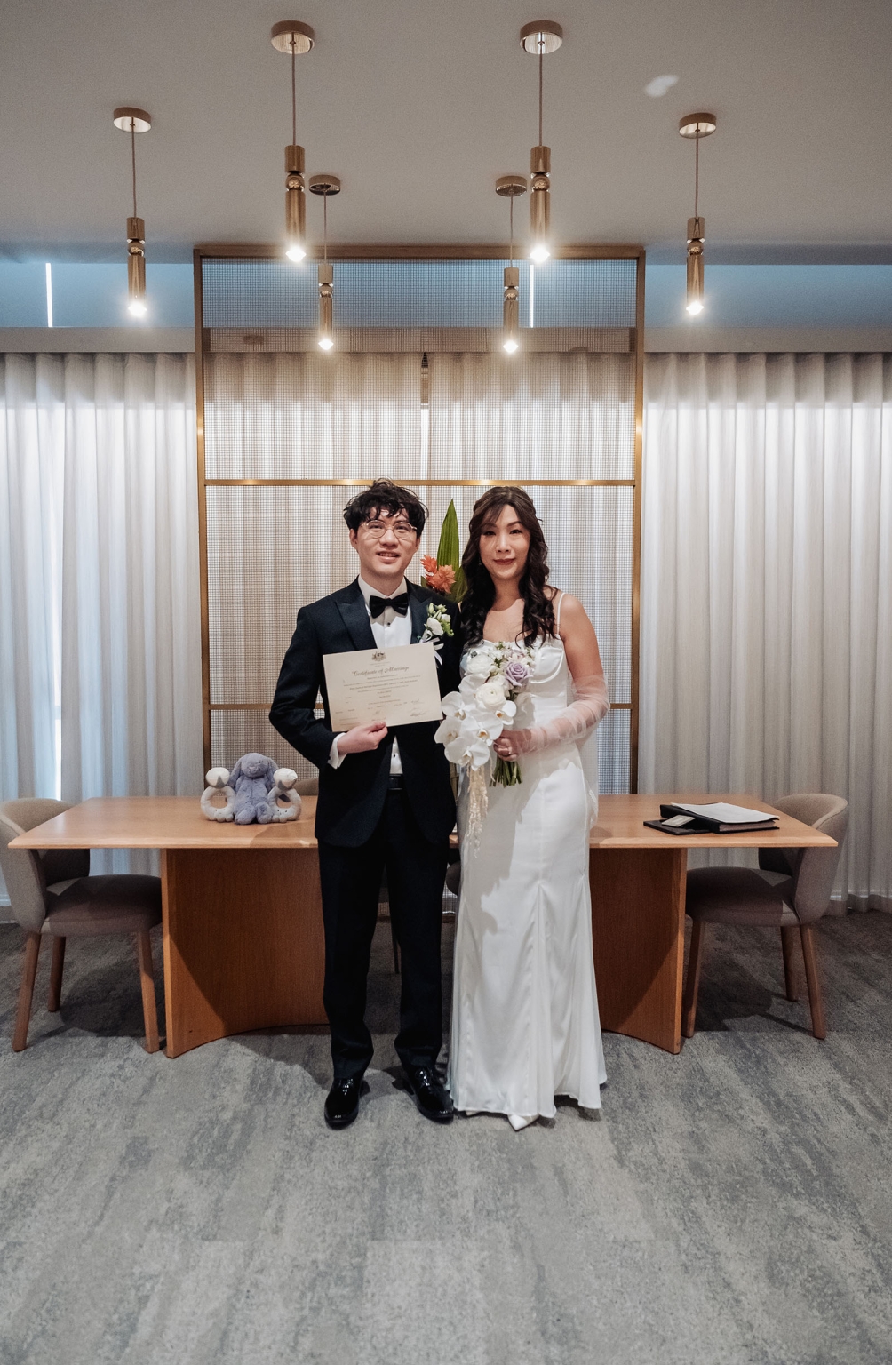 marriage rego office wedding – teri & thomas 10 Teri and Thomas standing at the Adelaide Marriage and Registration Office, holding their marriage certificate and bridal bouquet