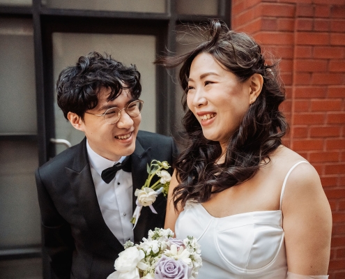Teri and Thomas smiling together outside the Adelaide Marriage and Registration Office after their wedding ceremony