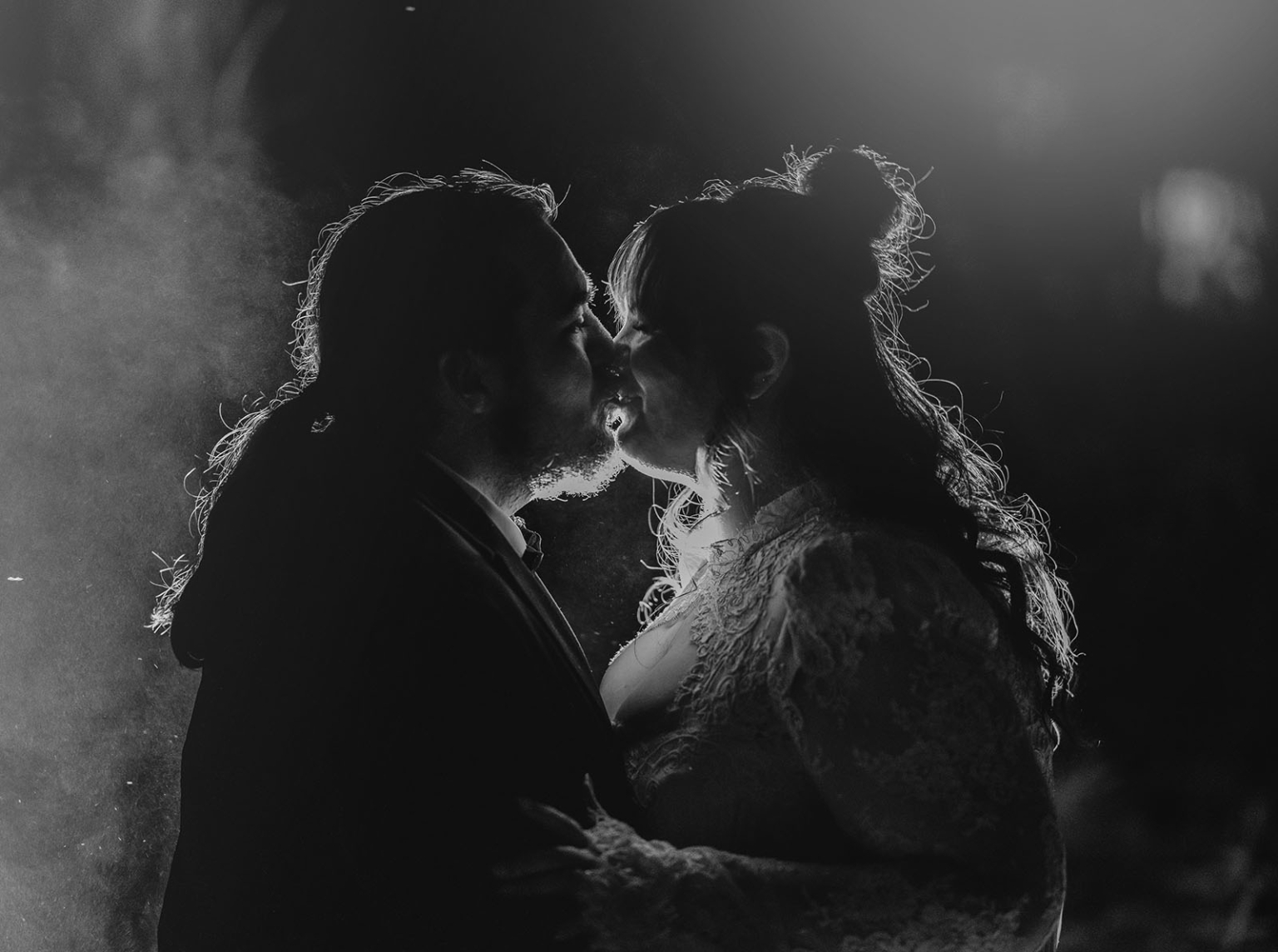 burbrook wedding – amber & angus | kuitpo forest wedding 67 Amber and Angus kissing in a backlit black-and-white wedding portrait