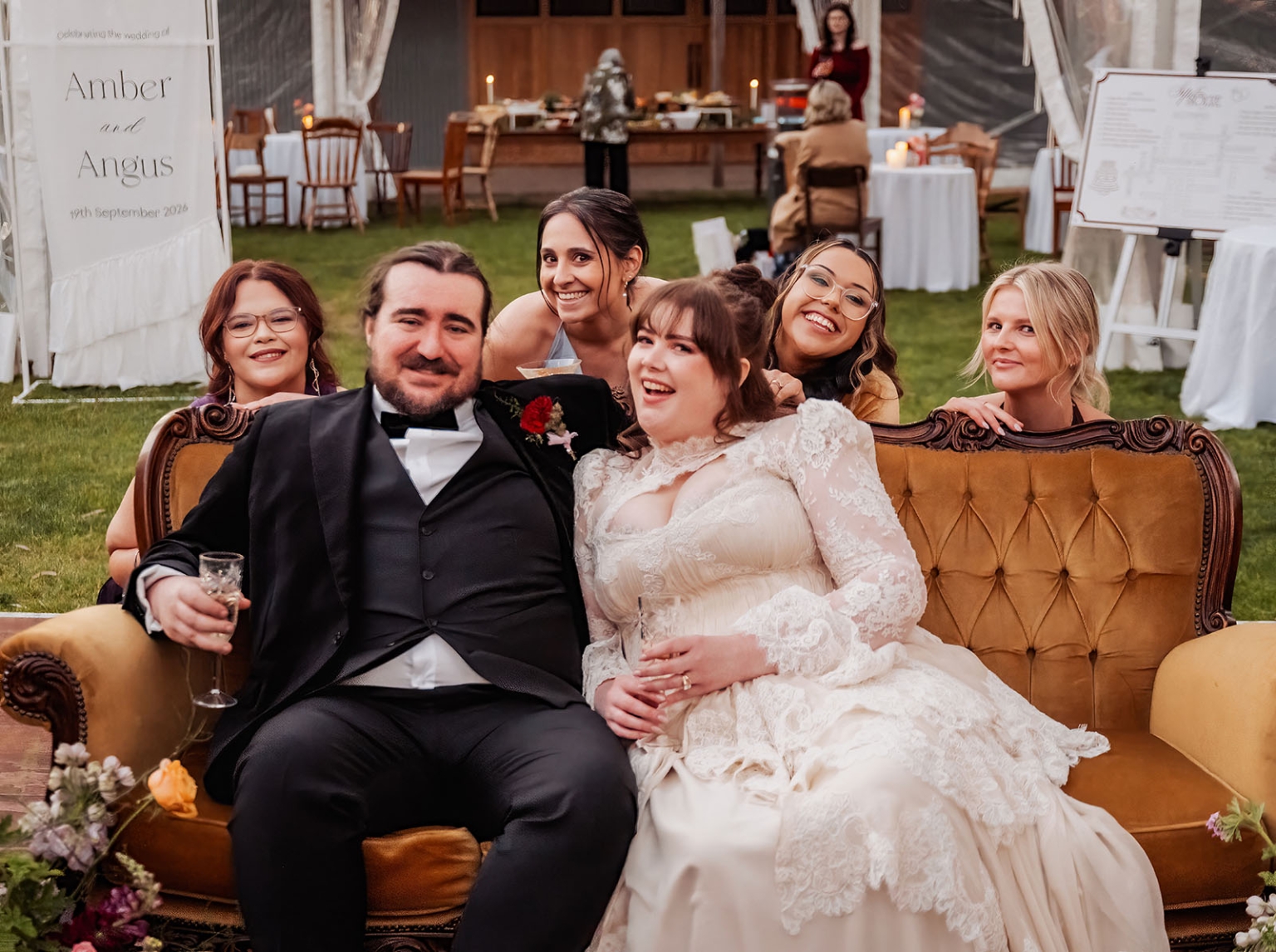 burbrook wedding – amber & angus | kuitpo forest wedding 55 Amber and Angus seated on a vintage mustard lounge with five smiling wedding guests at their reception