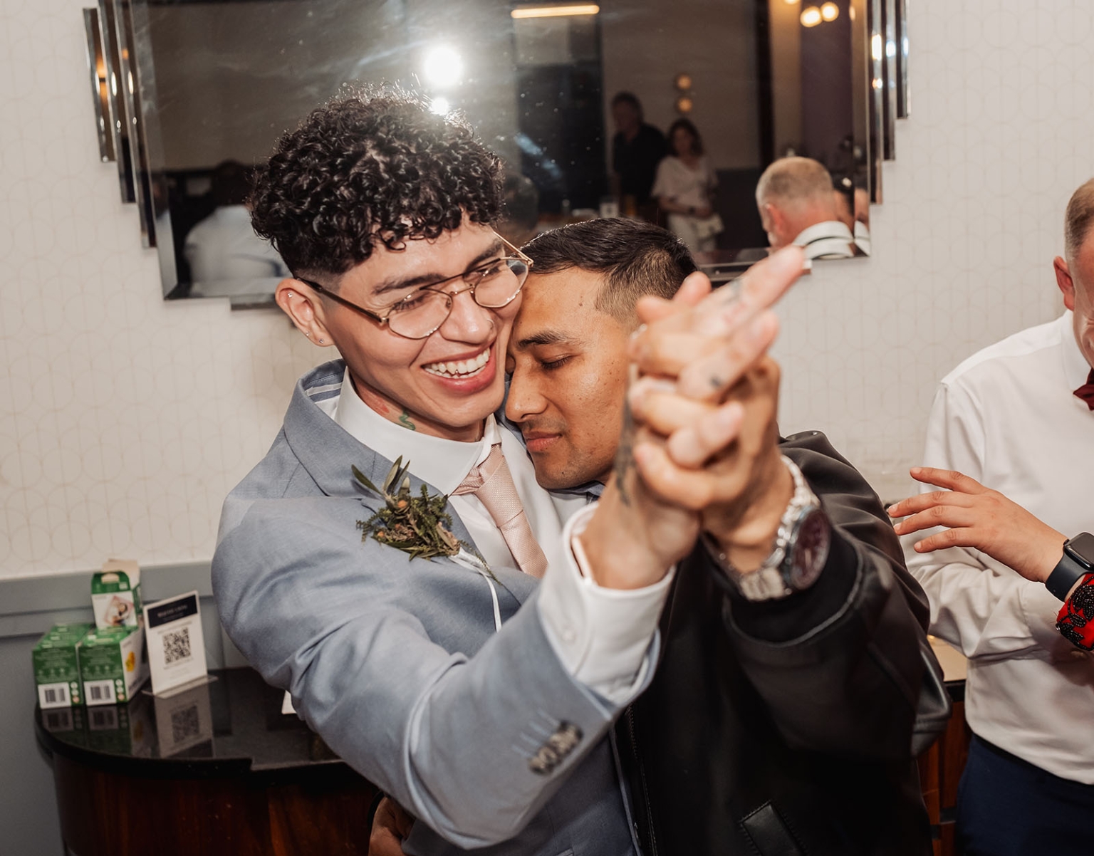 hotel royal wedding - brad & manuel 35 Brad and Manuel dancing closely together at their wedding reception, with guests behind them