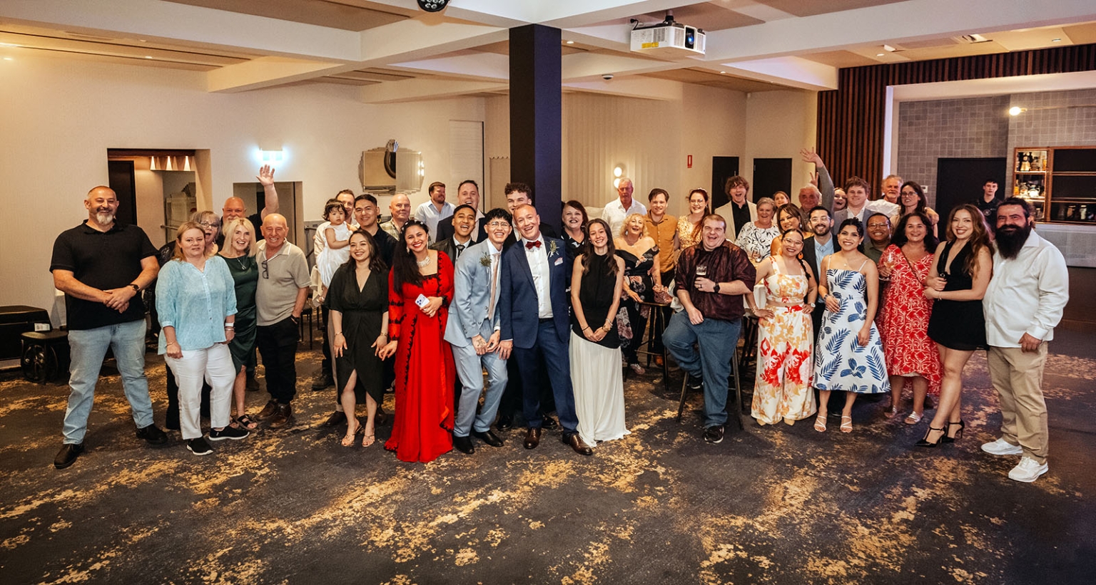 hotel royal wedding - brad & manuel 32 Brad and Manuel standing with a large group of smiling wedding guests at Hotel Royal