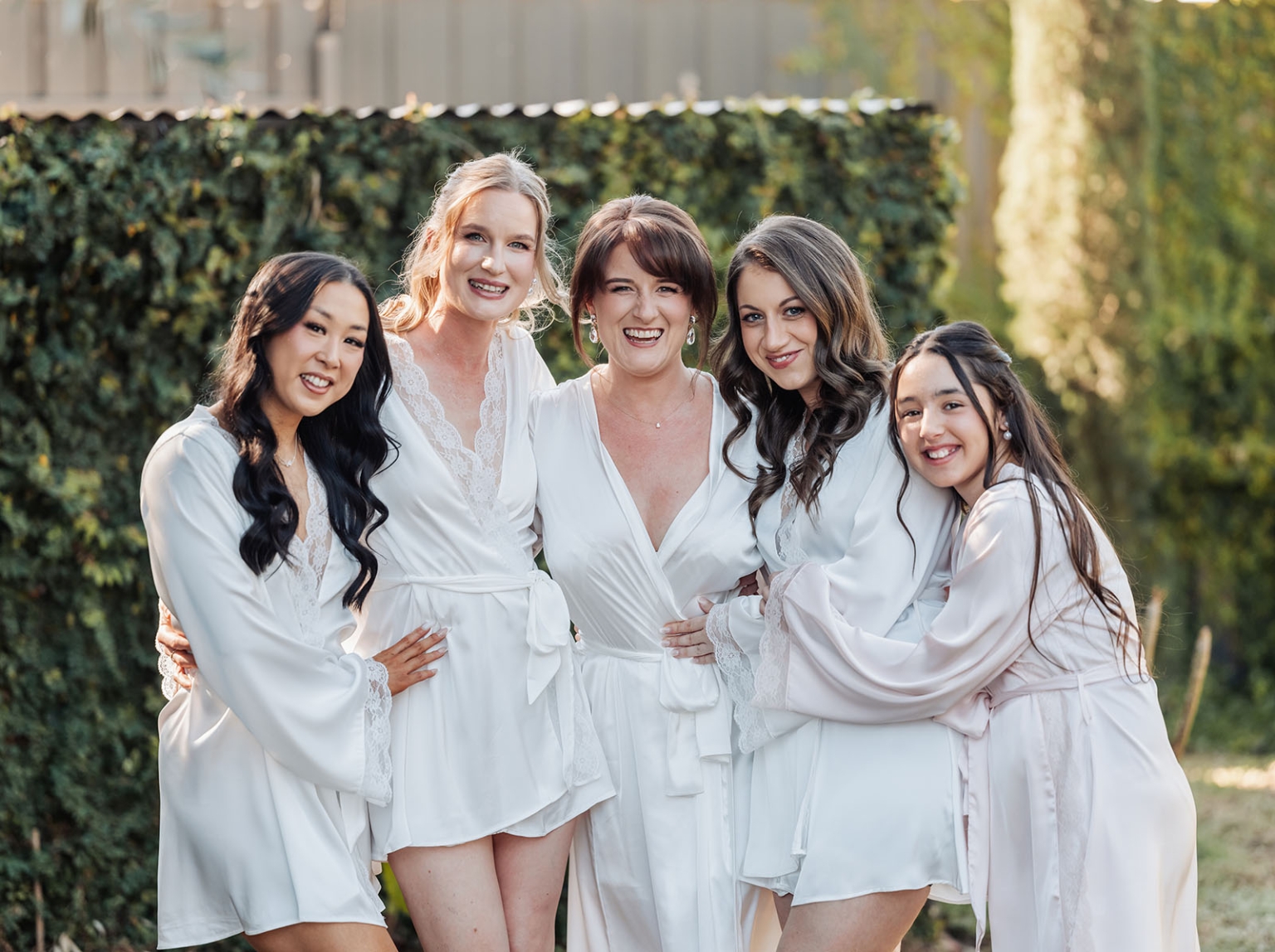 serafino winery wedding – maor & sasha 17 Bride and four bridesmaids smiling together outdoors in satin getting-ready robes