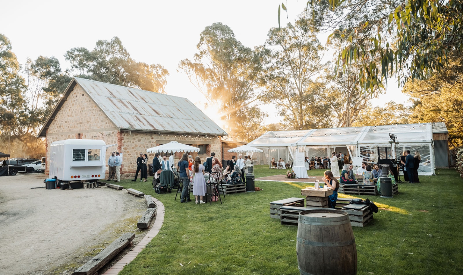 burbrook wedding – amber & angus | kuitpo forest wedding 50 Wedding guests mingling on the lawn beside a rustic stone building and clear marquee at Burbrook Forest