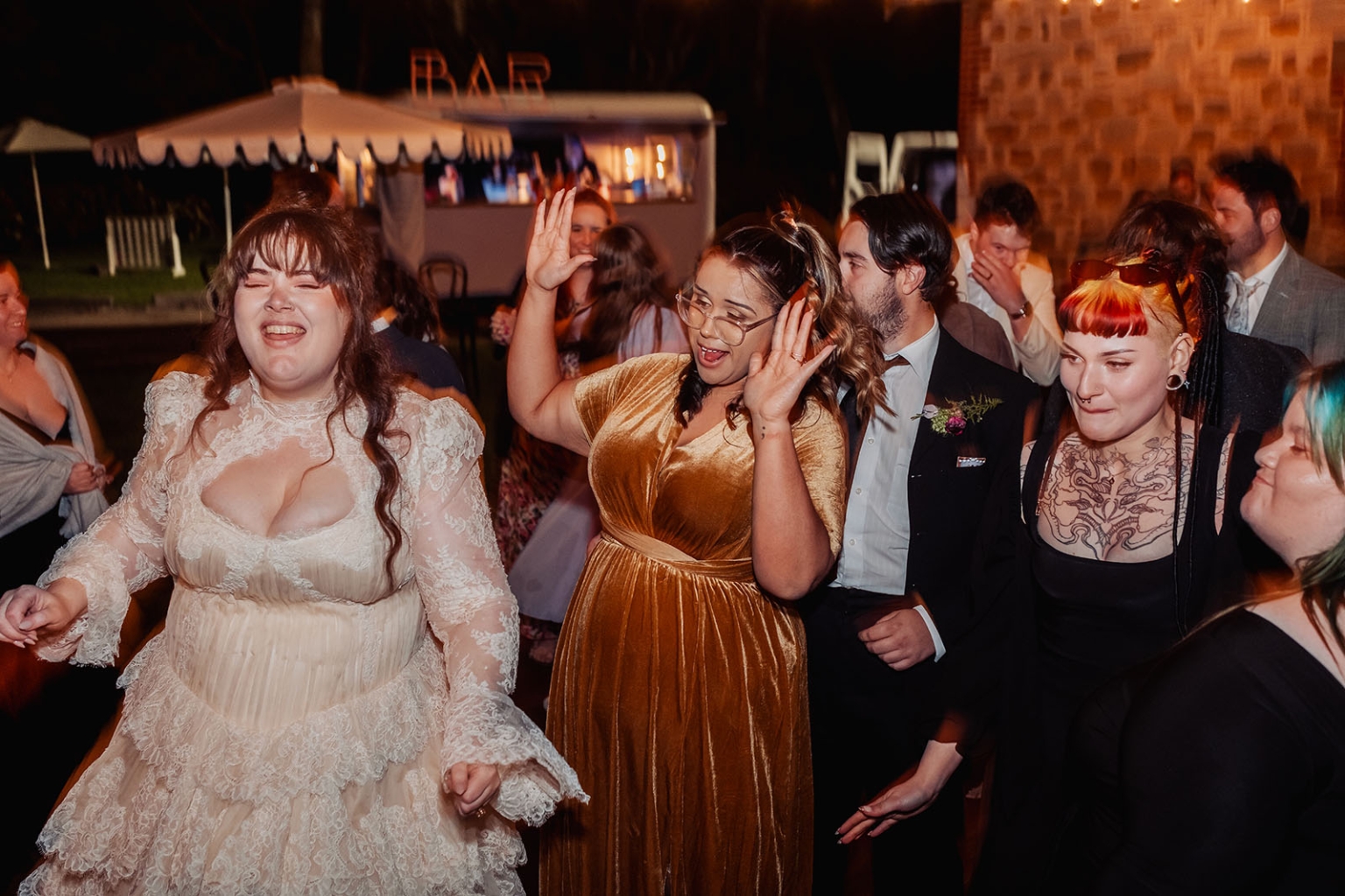 burbrook wedding – amber & angus | kuitpo forest wedding 63 Bride in a lace wedding dress dancing with guests at an outdoor evening reception