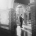 Bride and groom embracing beneath the arched brick portico at St Joseph's Chapel in Kensington