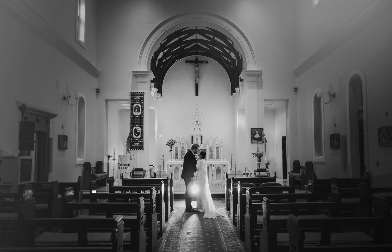 st joseph's chapel wedding – diana & michael 28 Newlywed couple kissing in the aisle before the altar at St Joseph's Chapel, Kensington