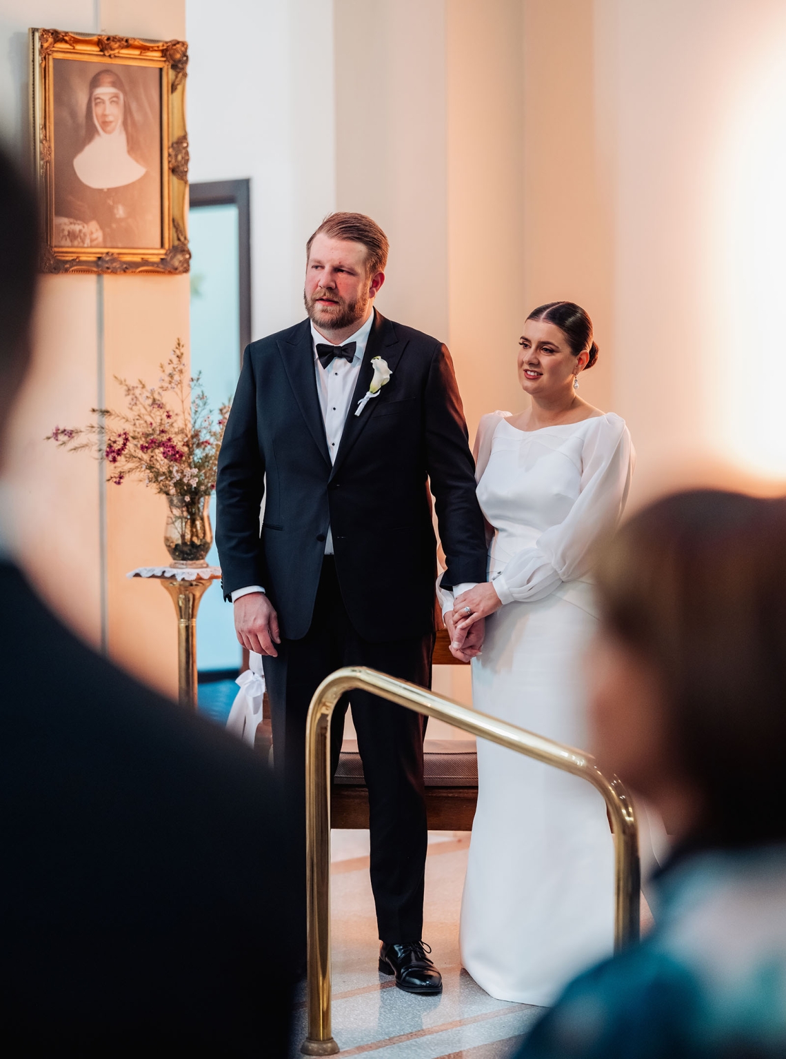 st joseph's chapel wedding – diana & michael 15 Bride and groom holding hands during their ceremony at St Joseph's Chapel, Kensington