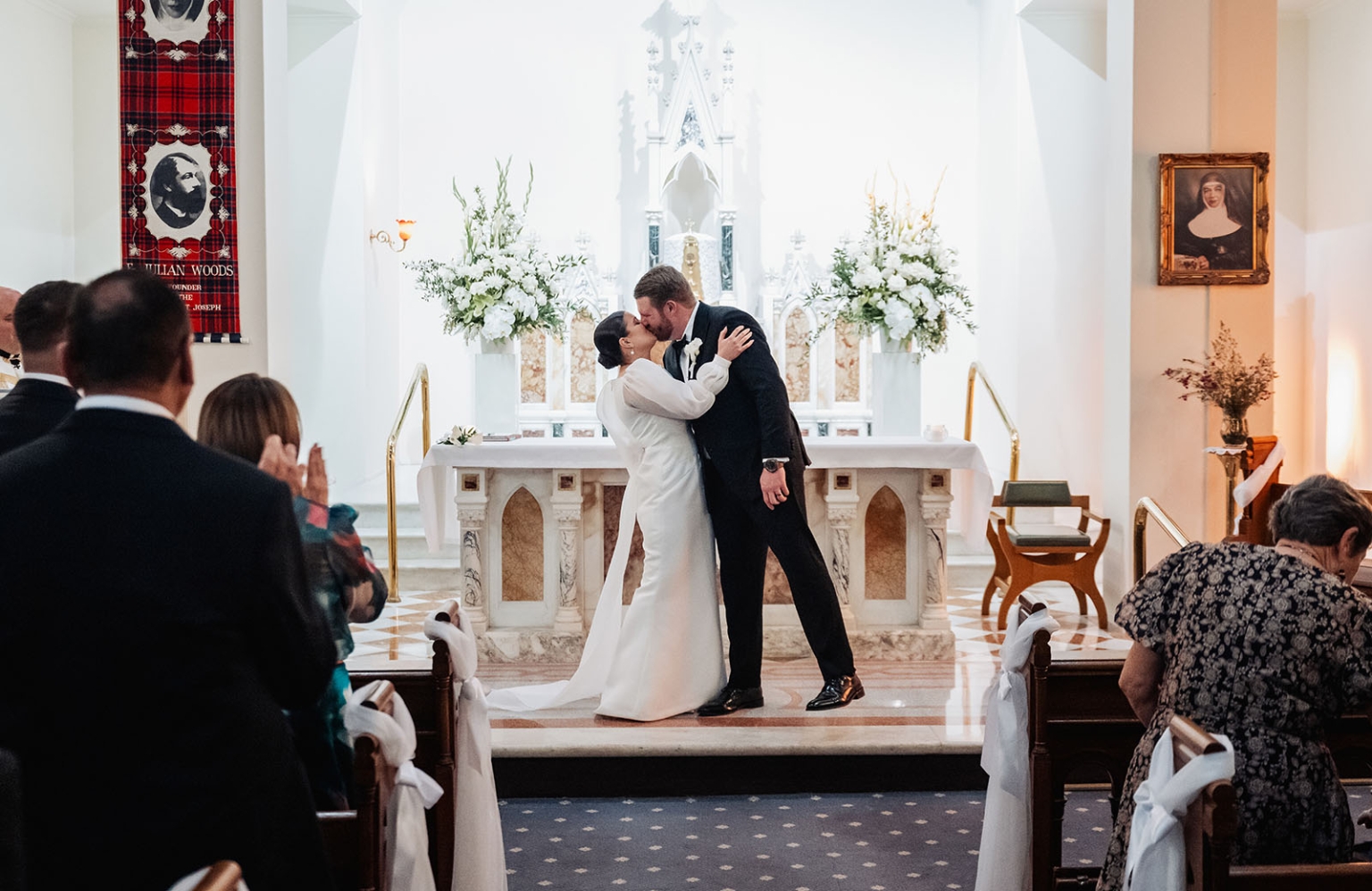 st joseph's chapel wedding – diana & michael 17 Diana and Michael kiss at the altar during their wedding ceremony at St Joseph's Chapel in Kensington.