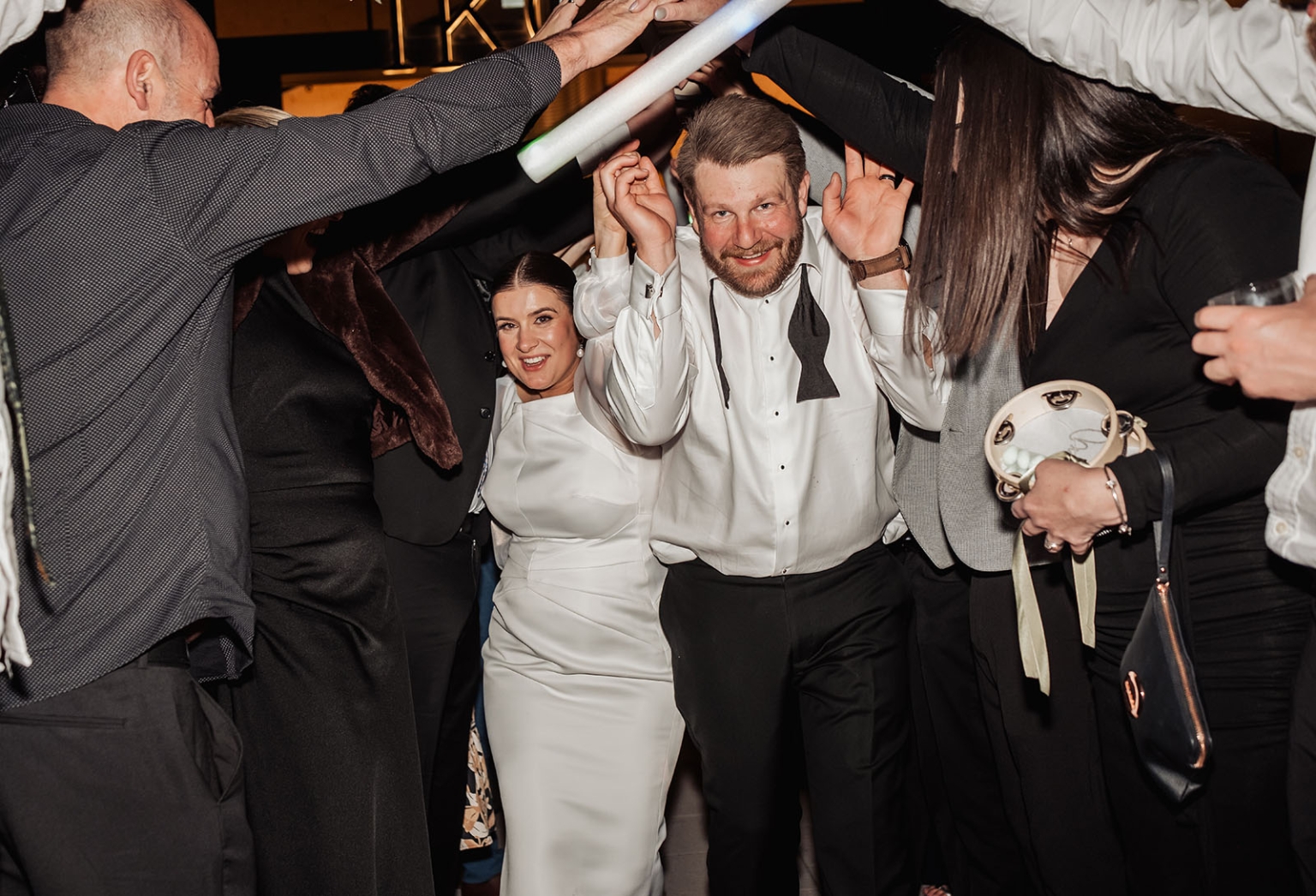 st joseph's chapel wedding – diana & michael 62 Diana and Michael dance beneath raised foam light sticks as wedding guests surround them