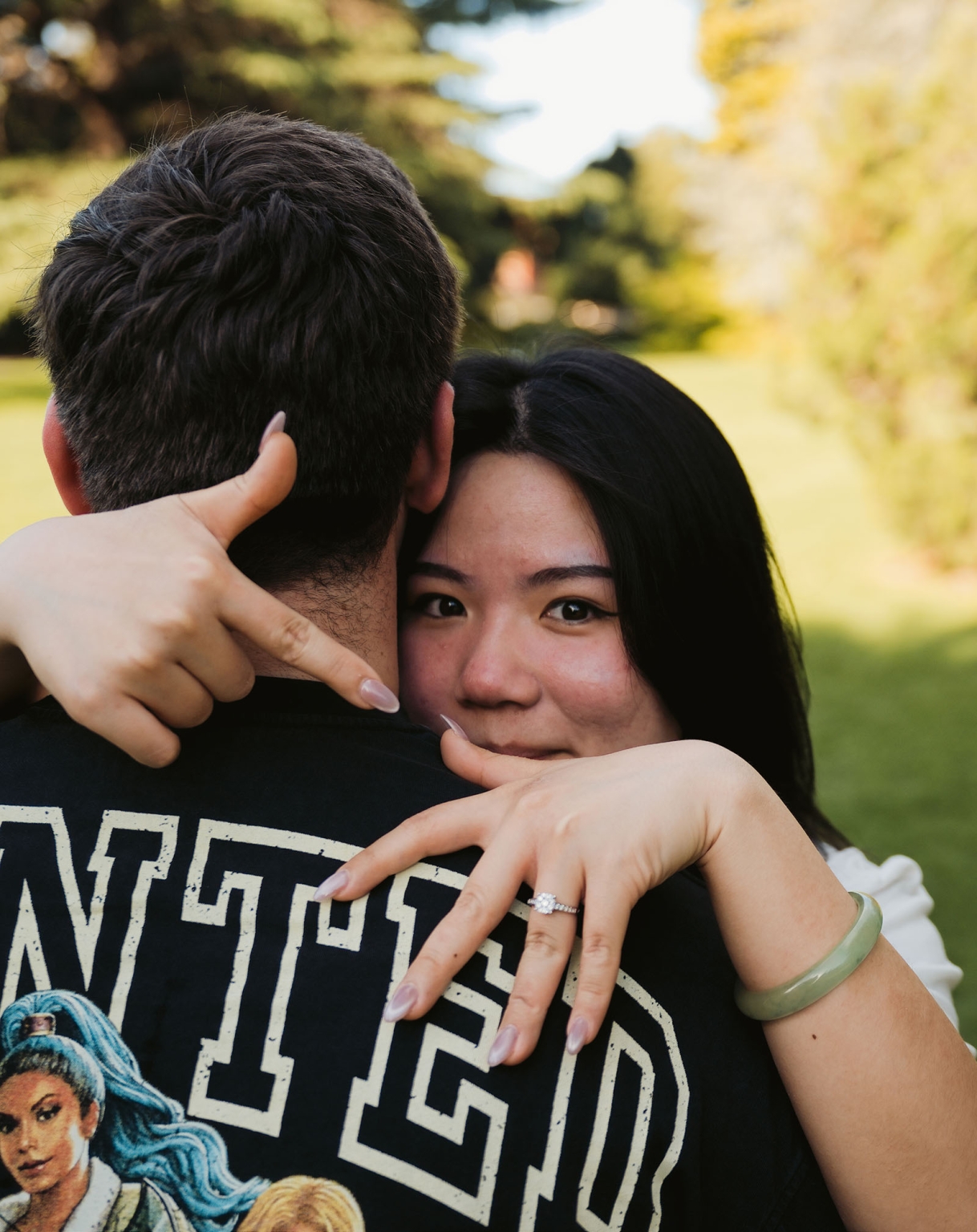 adelaide botanic gardens proposal – stewart & levi 23 Woman embracing a man and showing her engagement ring at Adelaide Botanic Gardens