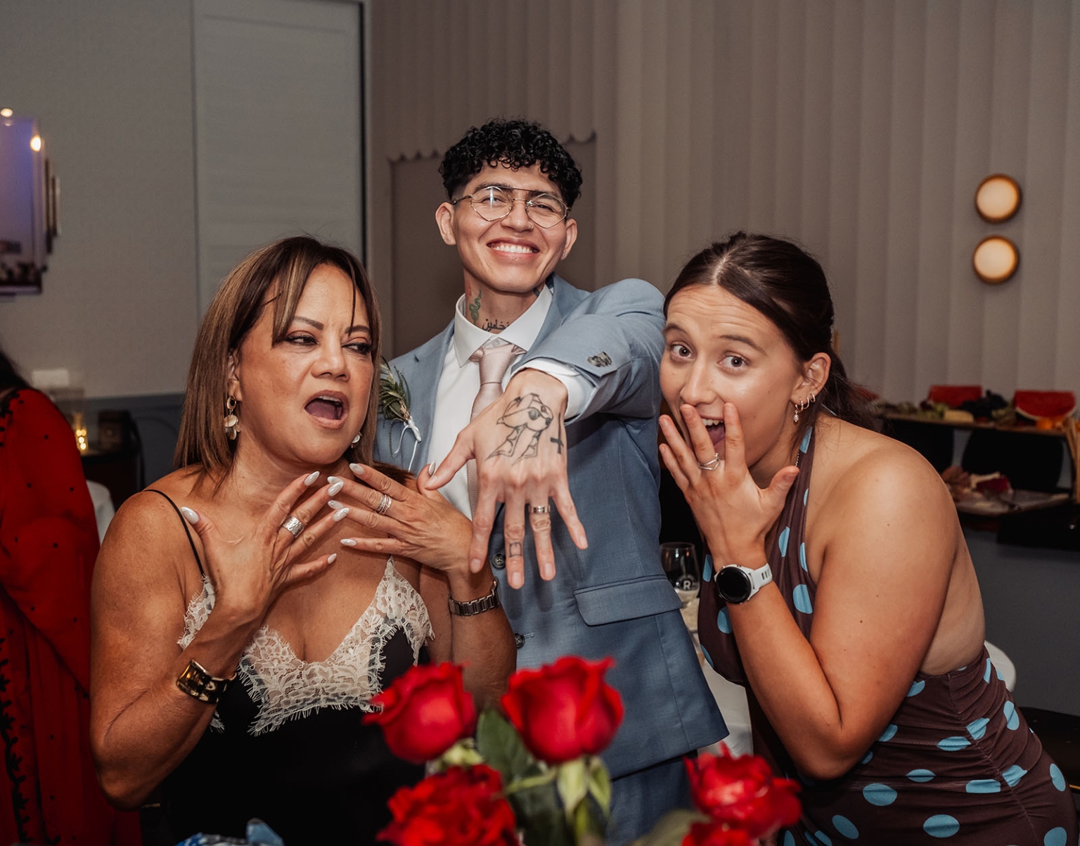 hotel royal wedding - brad & manuel 42 Smiling groom in a light blue suit showing his wedding ring beside two surprised wedding guests