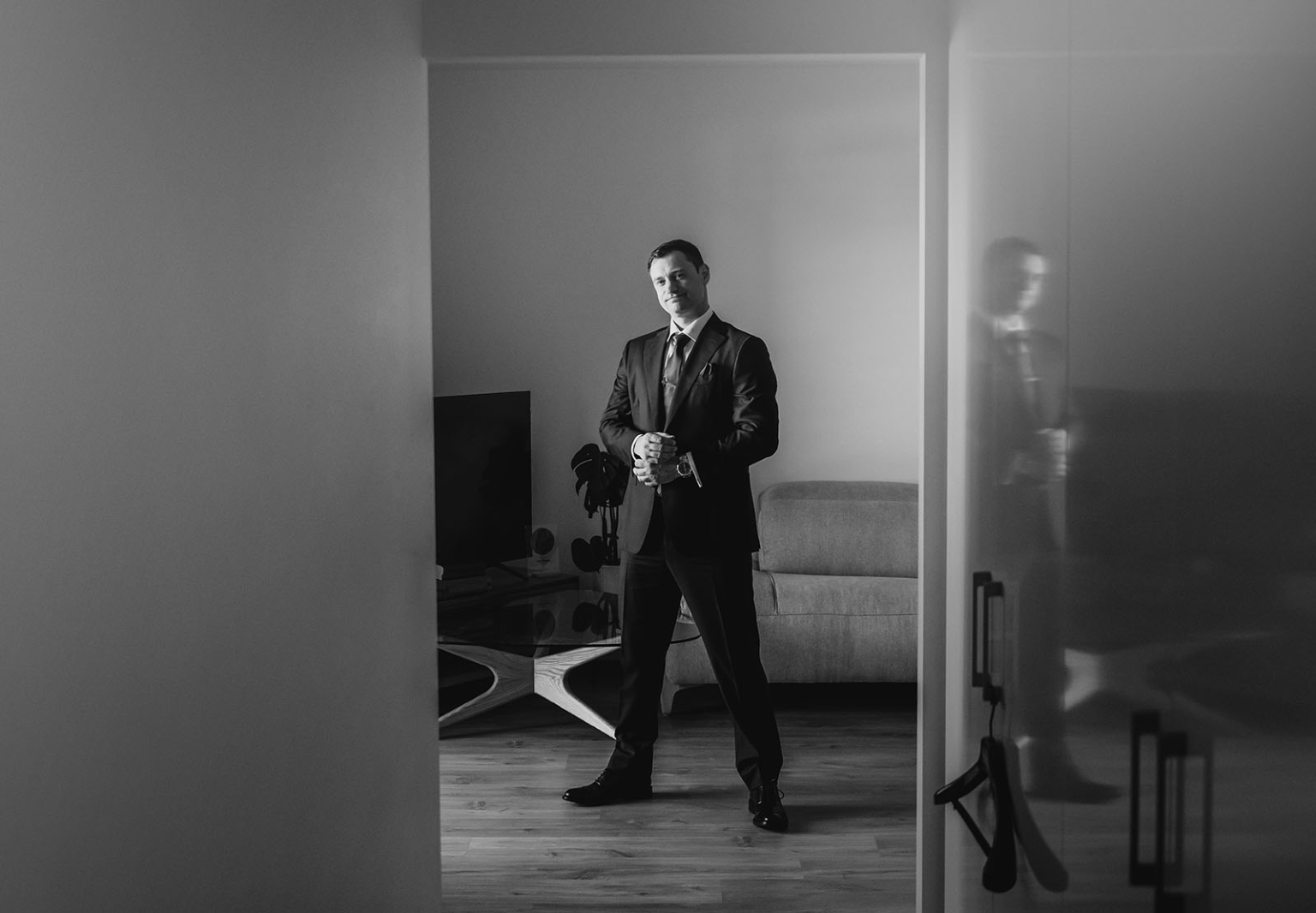 serafino winery wedding – maor & sasha 6 Maor wearing a dark suit and tie while preparing for his wedding in a Plympton apartment