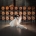 Bride and groom kissing in front of stacked Serafino Wines barrels at Serafino Winery