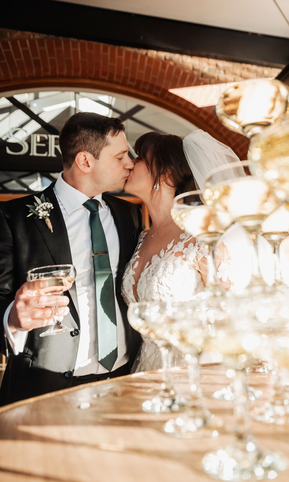 serafino winery wedding – maor & sasha 41 Bride and groom kissing beside a table of champagne glasses at Serafino Winery