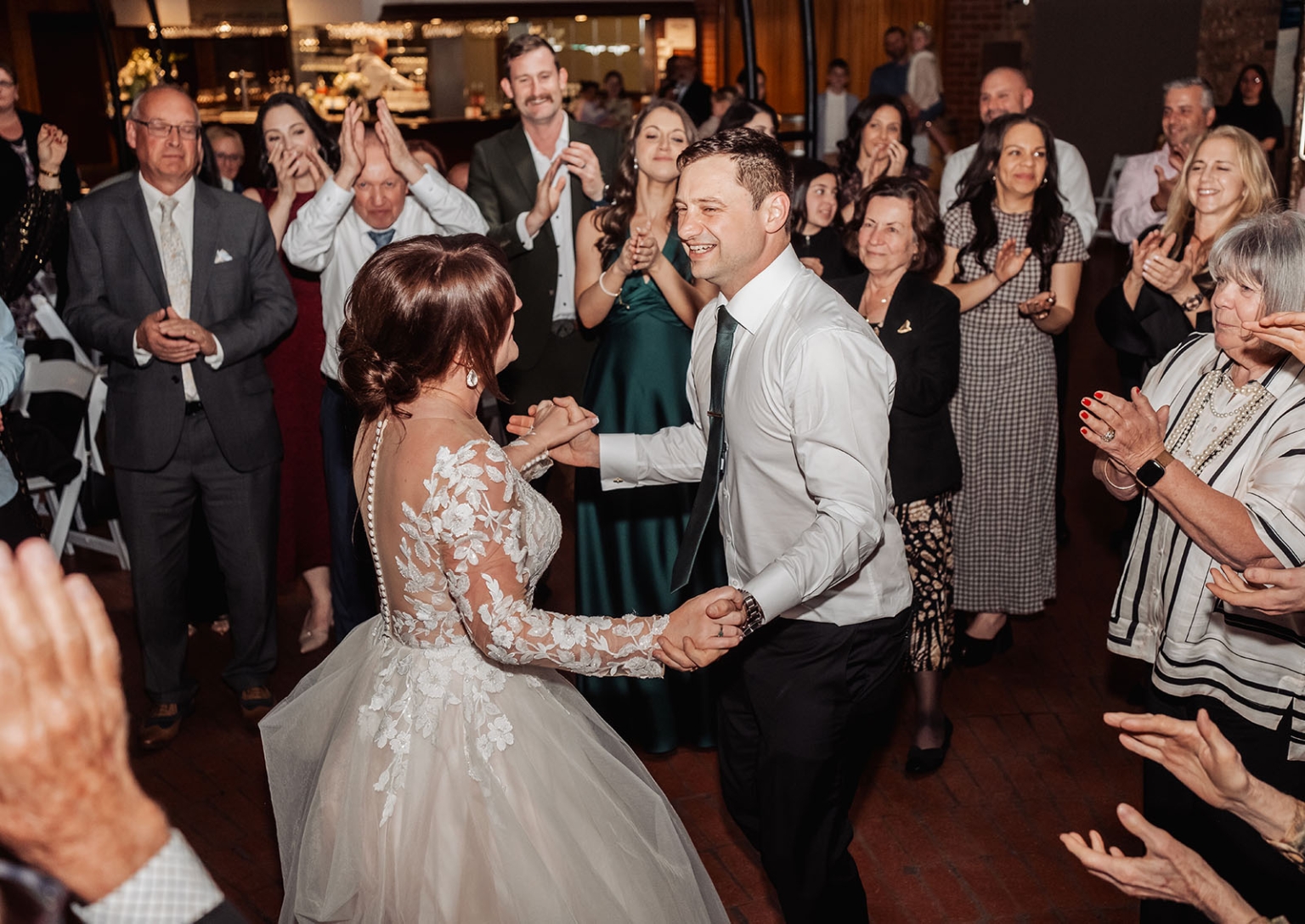 serafino winery wedding – maor & sasha 65 Bride and groom dancing hand in hand as wedding guests applaud around them at Serafino Winery