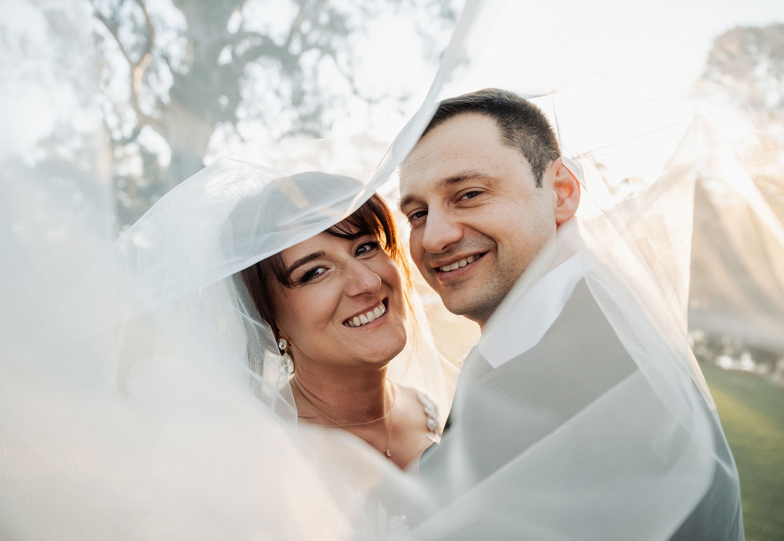 serafino winery wedding – maor & sasha 52 Bride and groom smiling together beneath the bride’s veil at Serafino Winery