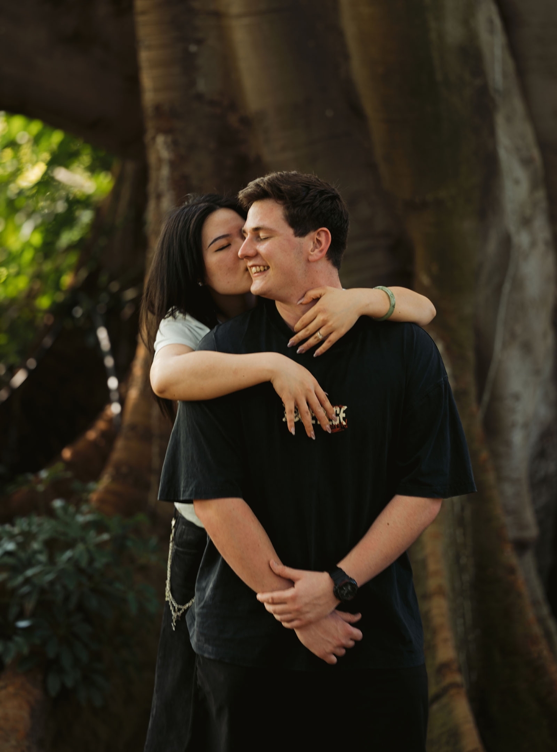 adelaide botanic gardens proposal – stewart & levi 17 Levi embraces and kisses Stewart beneath a large tree at Adelaide Botanic Gardens after their proposal.