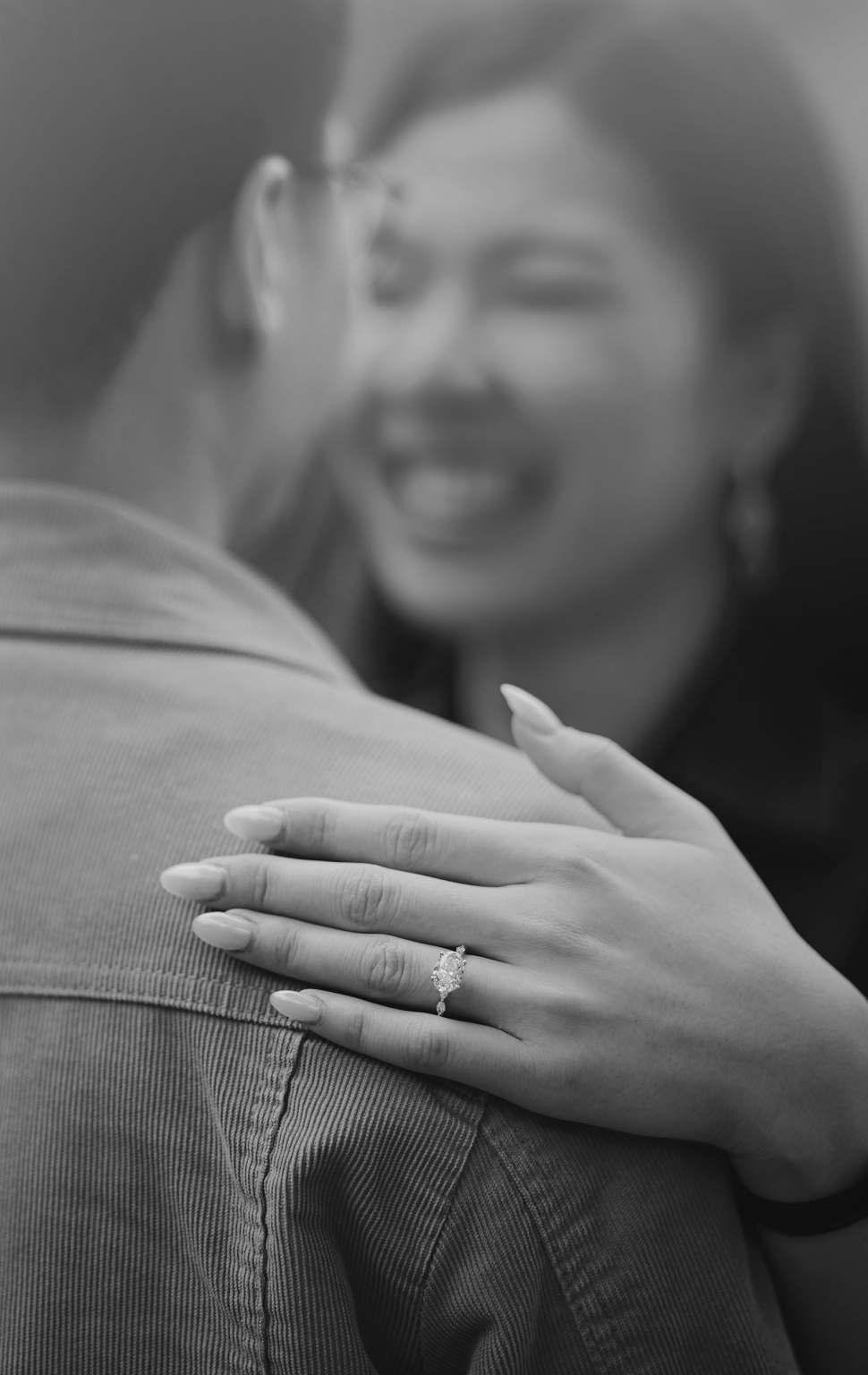 mt lofty botanic park proposal – watay & phouthun 10 Watay smiling as she embraces Phouthun, with her diamond engagement ring in focus on his shoulder.
