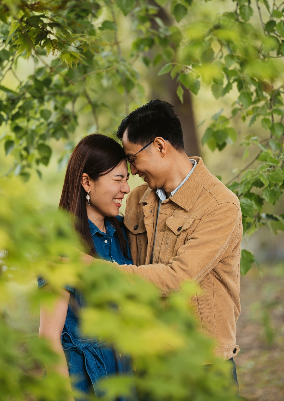 mt lofty botanic park proposal – watay & phouthun 22 Watay and Phouthun smiling with their foreheads together among leafy trees at Mount Lofty Botanic Garden
