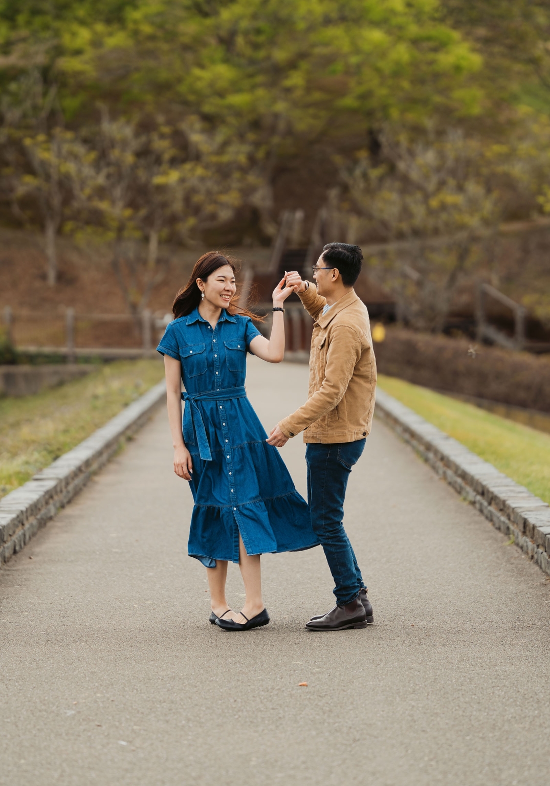 mt lofty botanic park proposal – watay & phouthun 24 Watay and Phouthun smiling as they hold hands on a garden path at Mount Lofty Botanic Garden