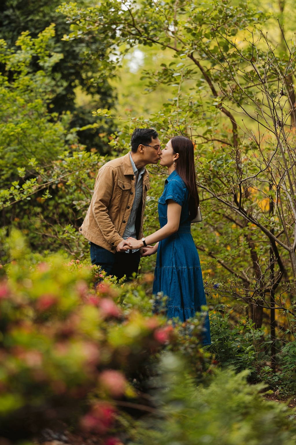 mt lofty botanic park proposal – watay & phouthun 15 Watay and Phouthun holding hands and kissing among leafy garden plants at Mount Lofty Botanic Garden