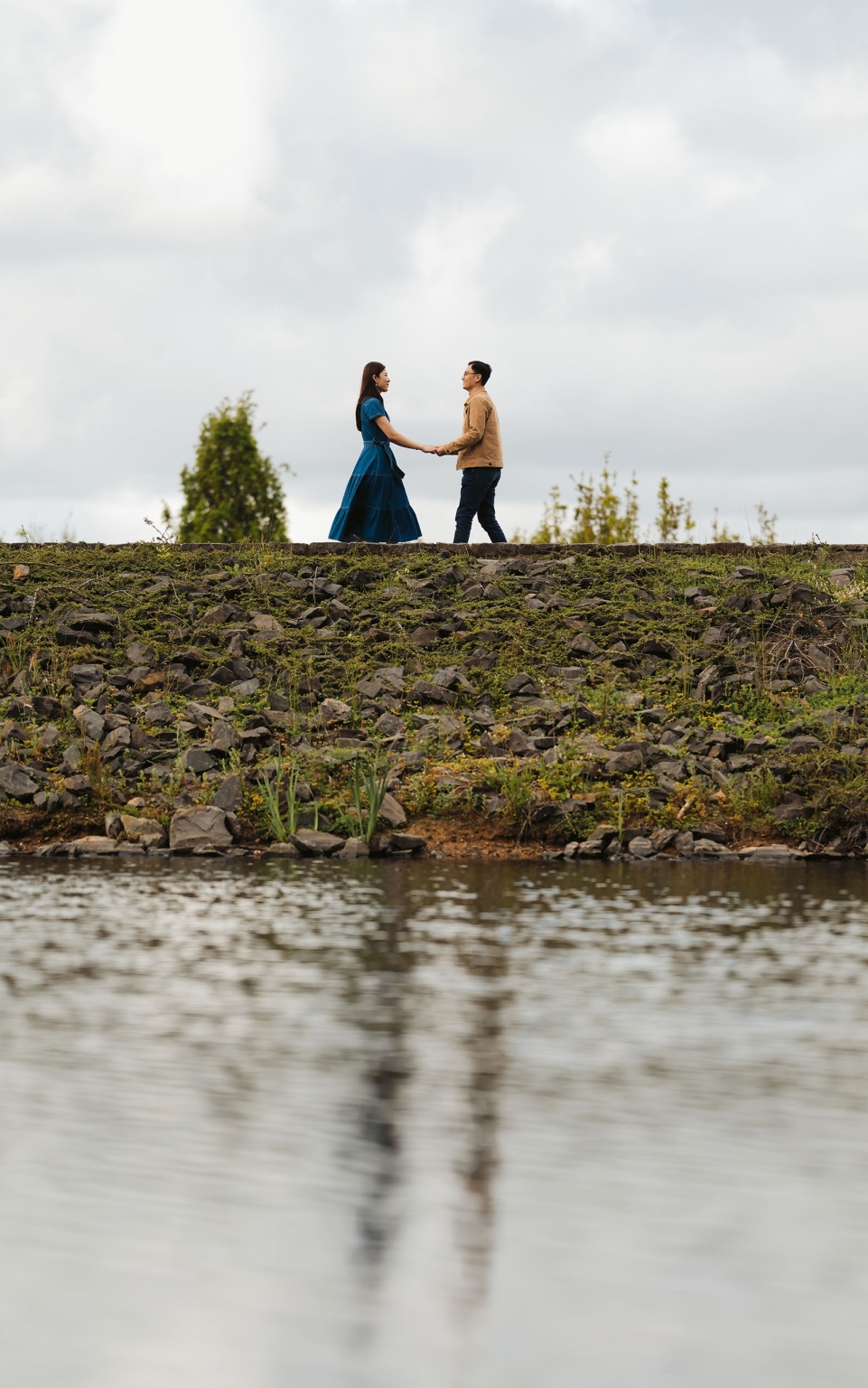 mt lofty botanic park proposal – watay & phouthun 26 Watay and Phouthun holding hands beside a lake at Mount Lofty Botanic Garden
