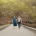 Watay and Phouthun holding hands as they walk along a stone-lined path at Mount Lofty Botanic Garden
